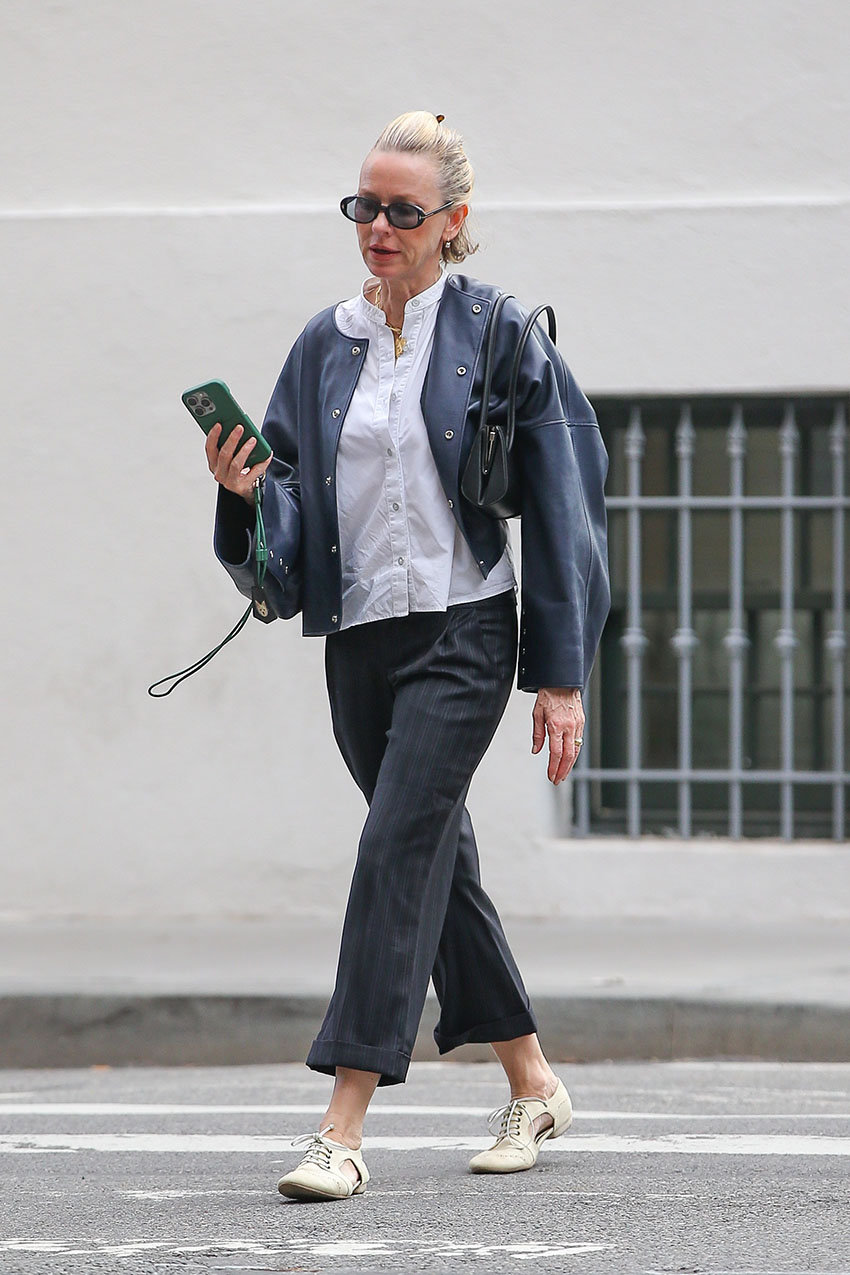 Naomi Watts wearing a white button-down, black leather jacket, black jeans, and white jazz shoes
