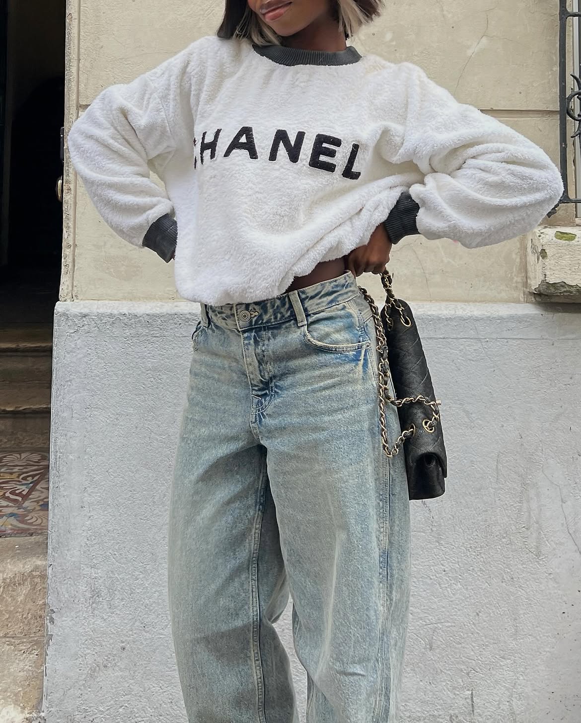 Jeans with Chanel logo sweatshirt.