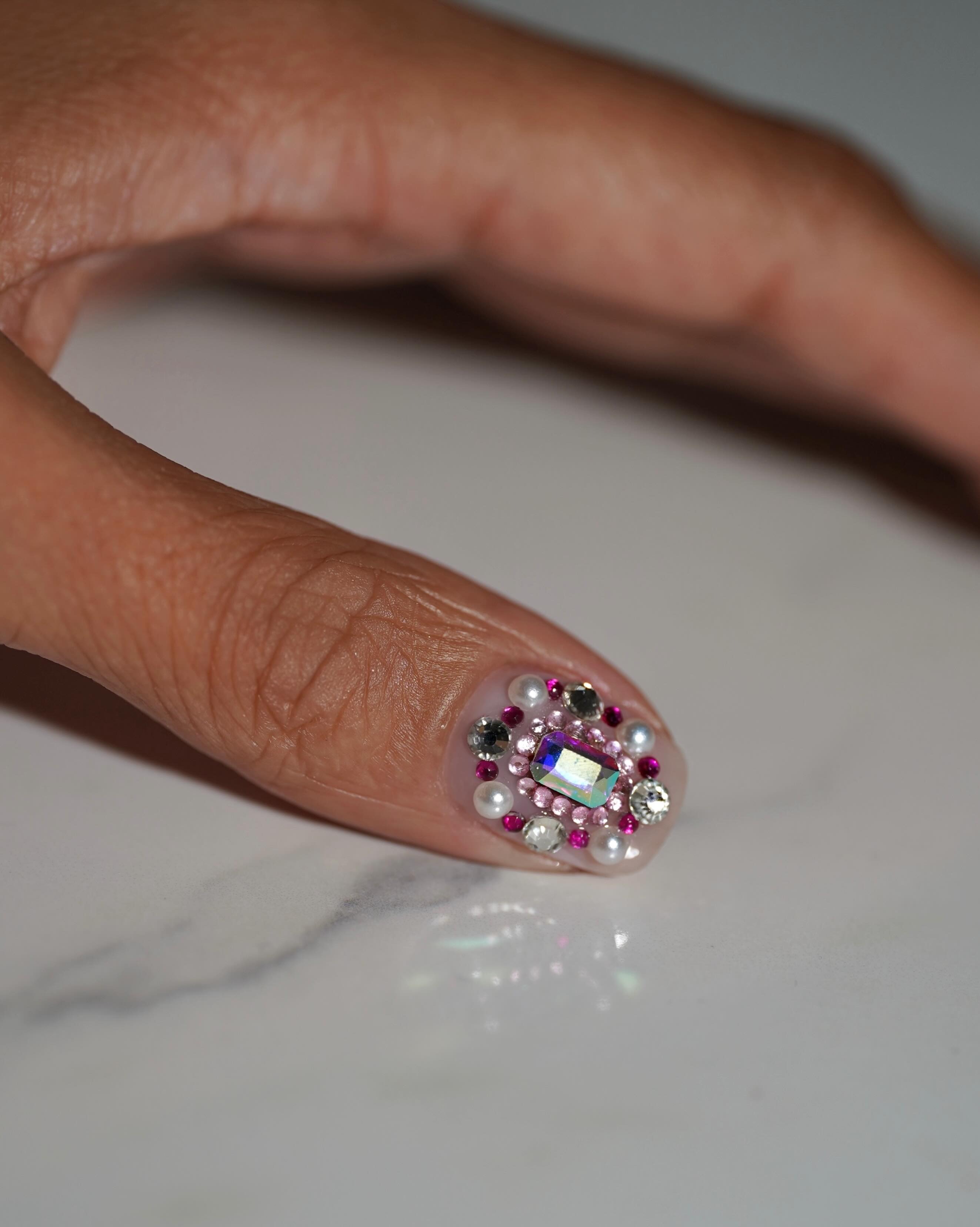 A multi-gem bedazzled manicure by @iramshelton