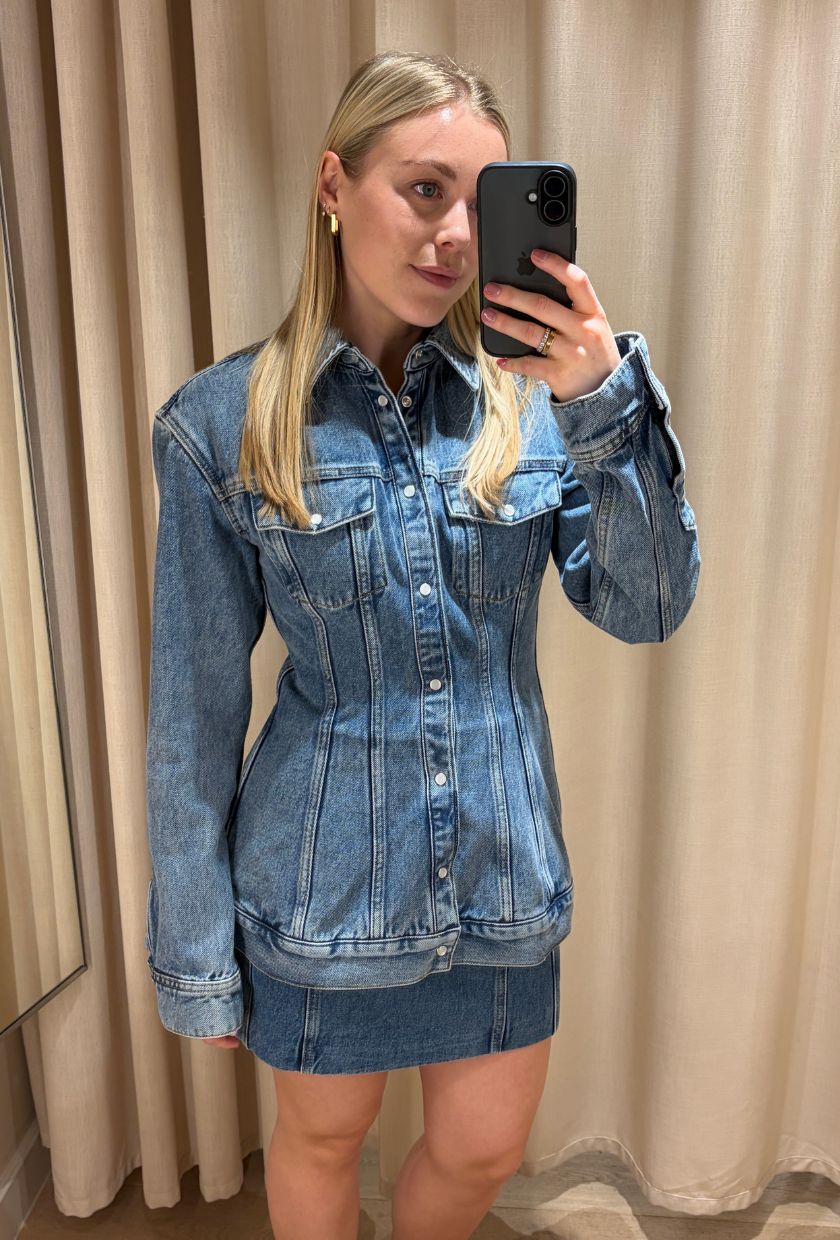 Woman wears denim jacket, denim skirt