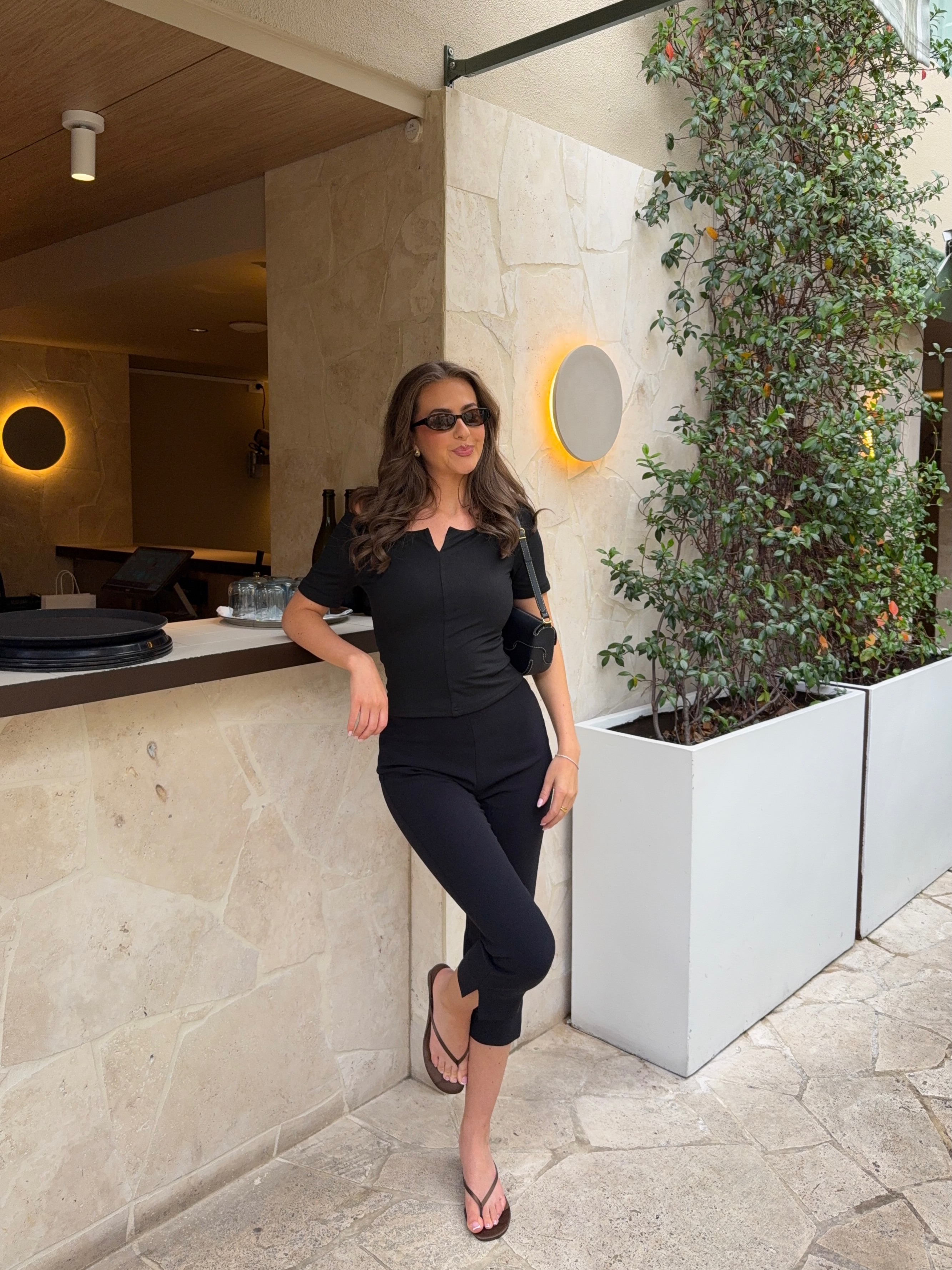 A woman wearing fall shoes with capri pants in 2026.