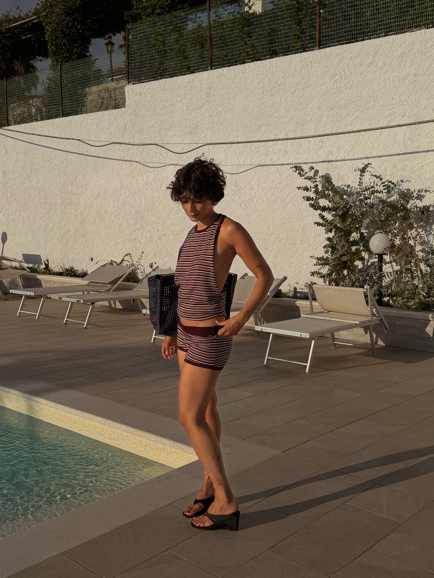 An image of a woman wearing skinny wedge sandals