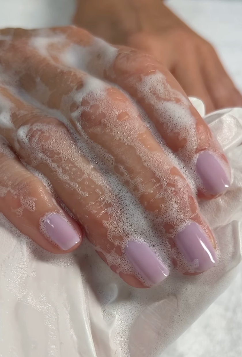 A close up shot of mauve milk nails