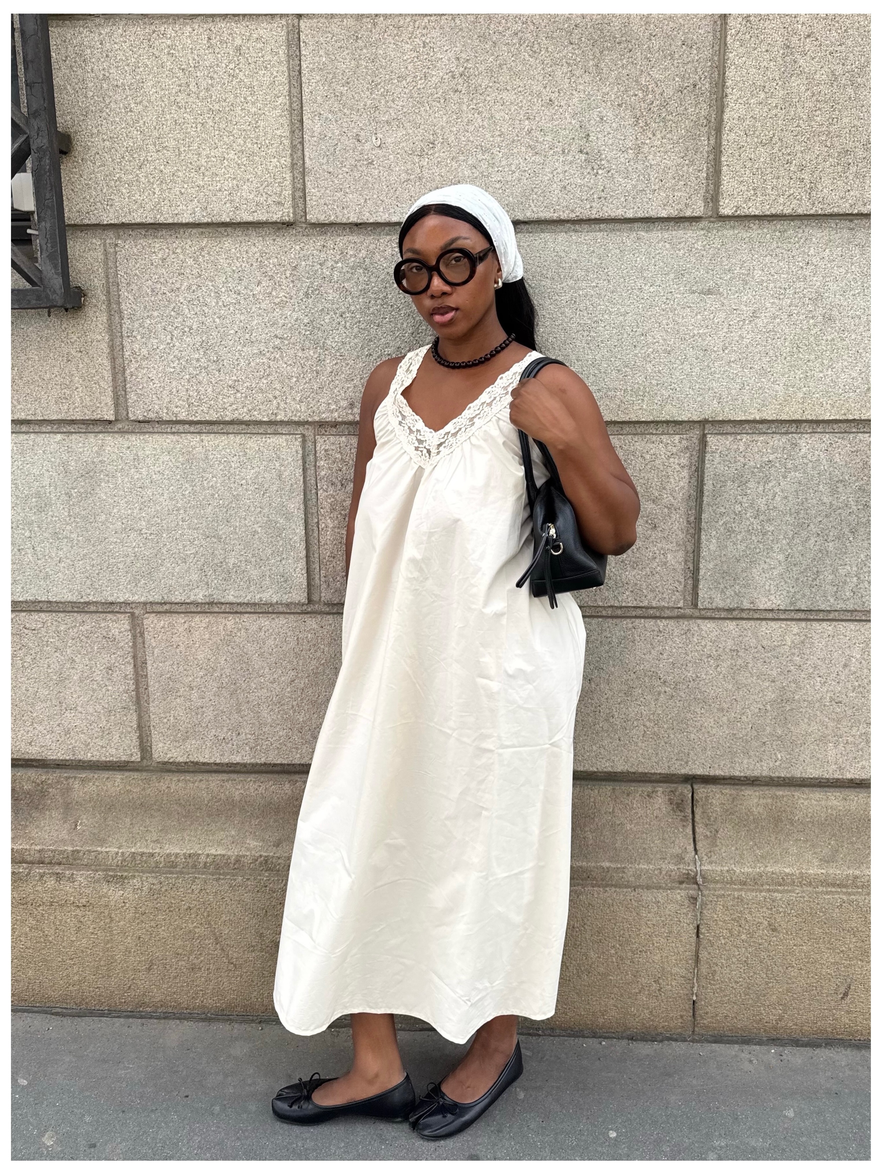@nnennaechem wearing a lace-trim dress, bandana, and ballet flats.