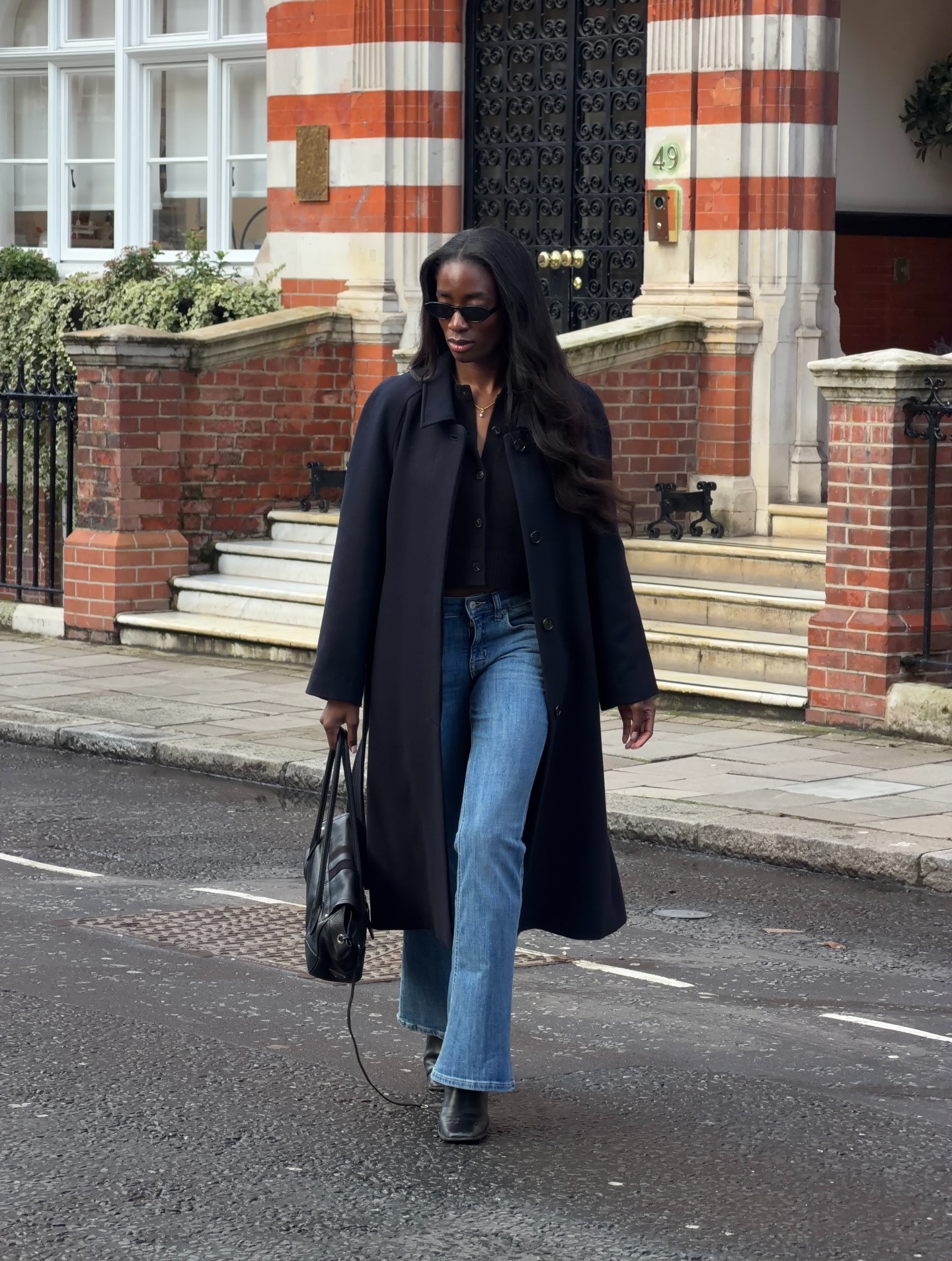 @_livmadeline in a cardigan, coat, and jeans.