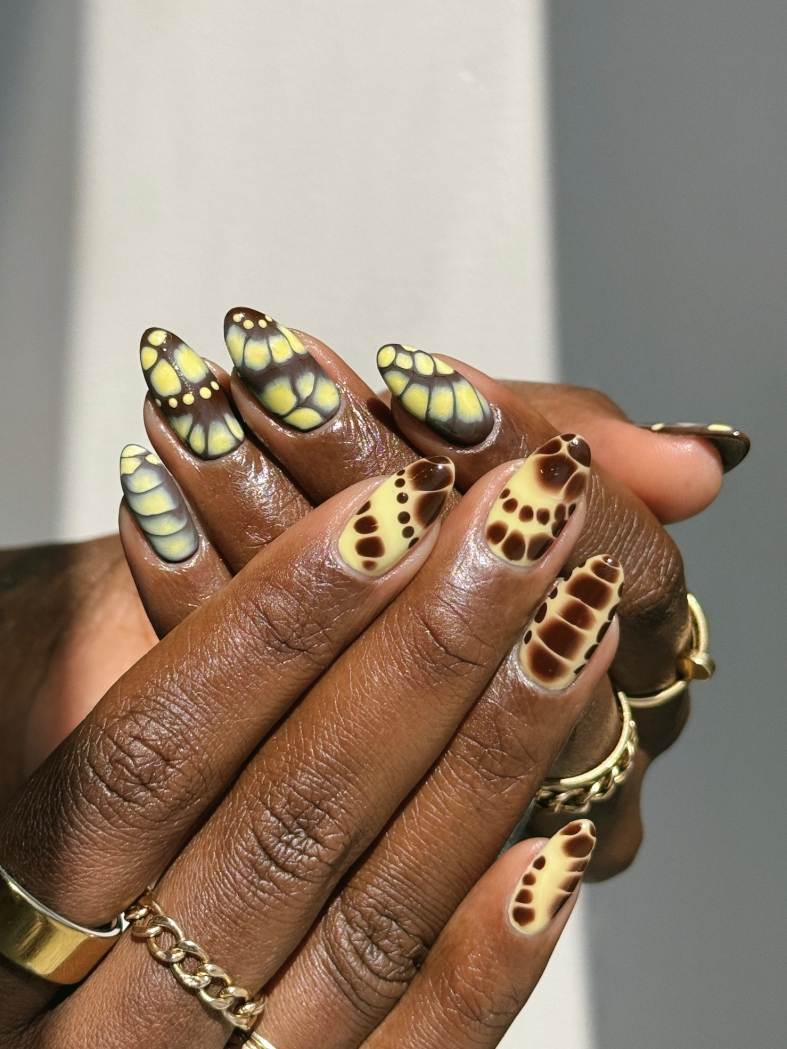 A yellow and brown reptile nail design.