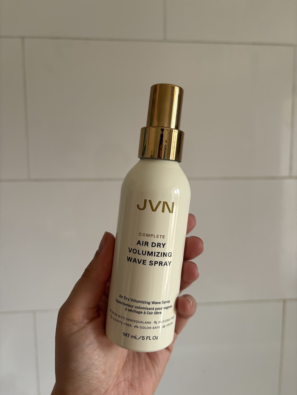 Mica Ricketts holding JVN Air Dry Volumizing Wave Spray