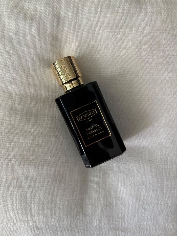 A picture of an Ex Nihilo perfume on a white linen background