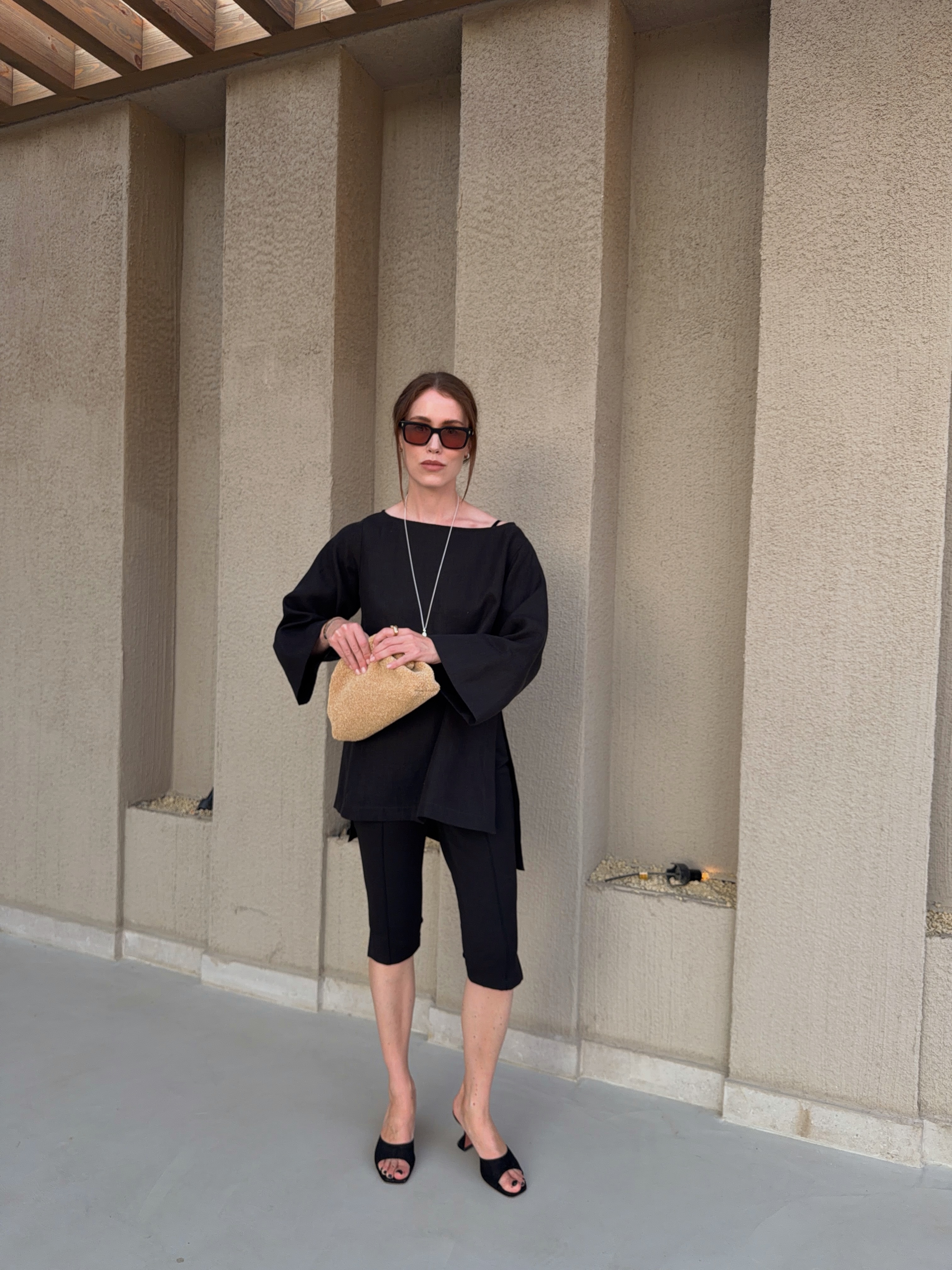 A woman wearing fall shoes with capri pants in 2026.