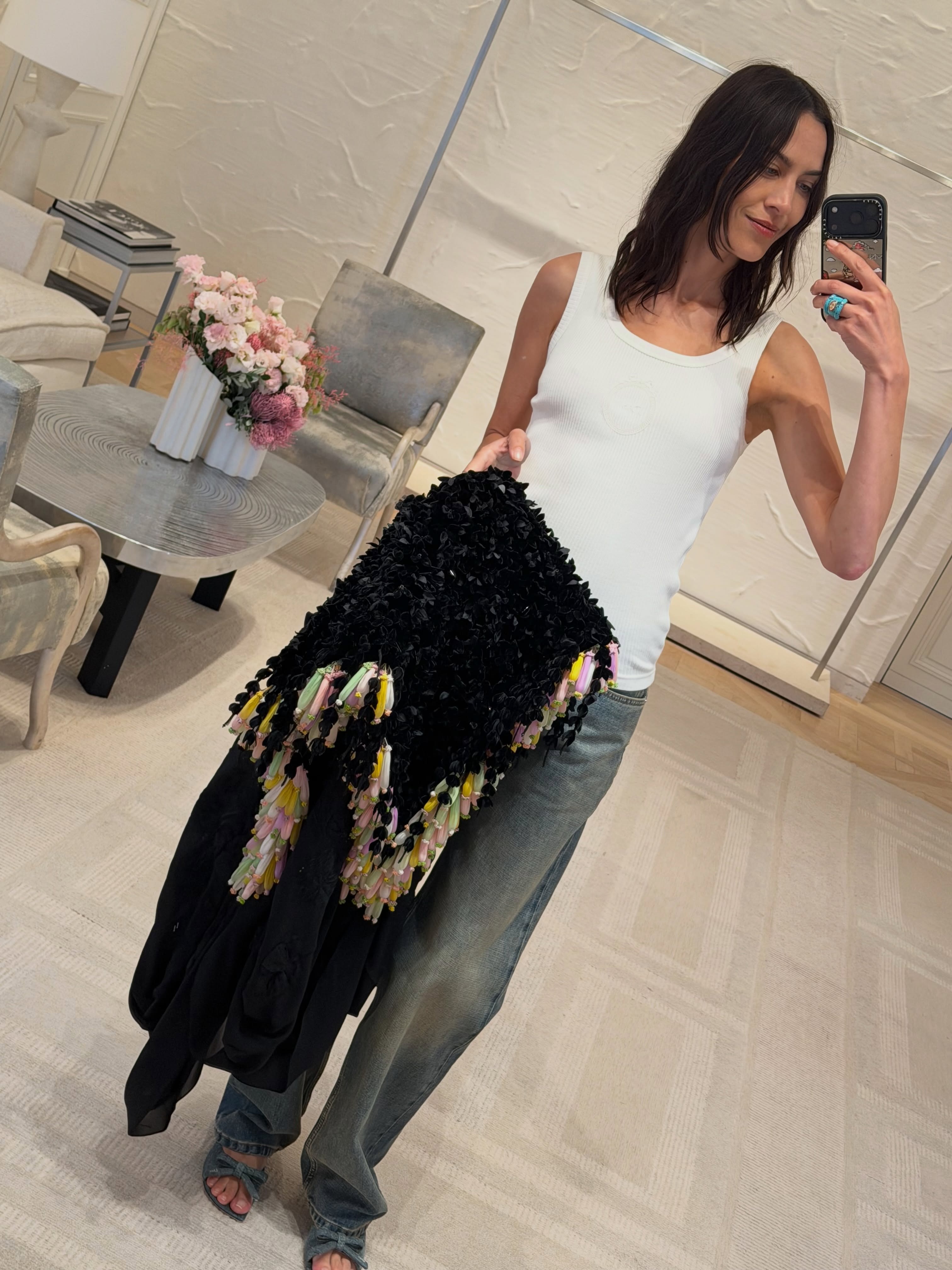 Alexa Chung wears denim heels with jeans and a white tank top.