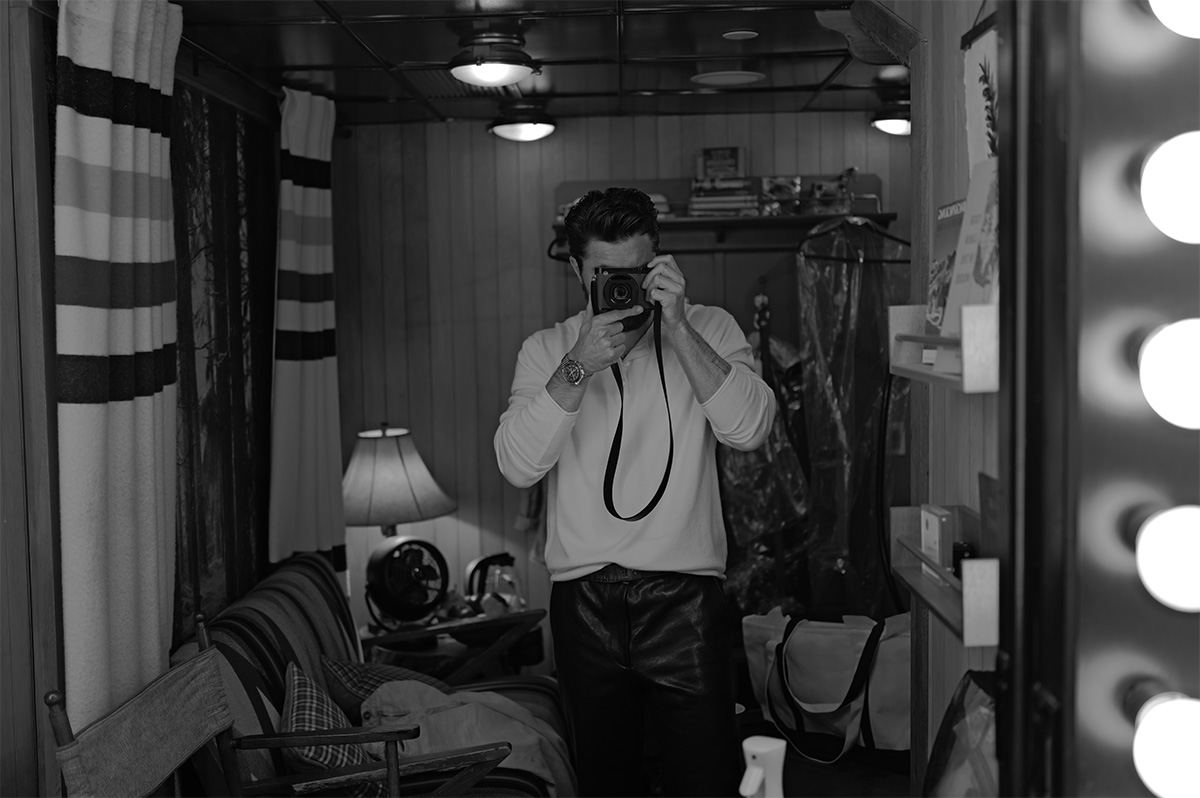 Self portrait of Chase Stokes taking a photo of himself in the mirror.