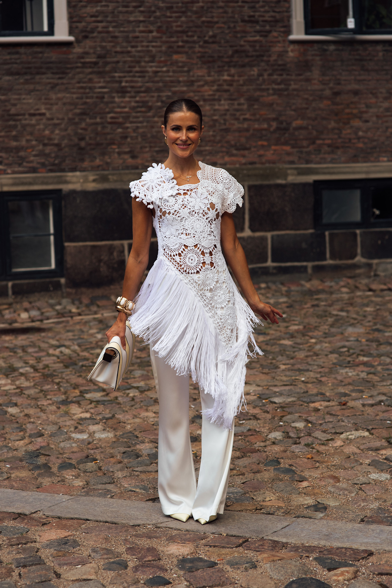 Woman wearing white dress at Copenhagen Fashion Week Spring Summer 2027.