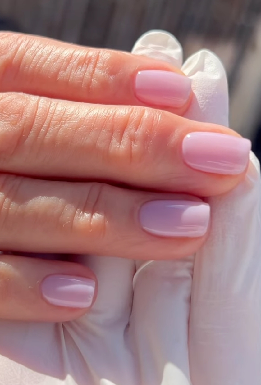 A close up shot of mauve milk nails