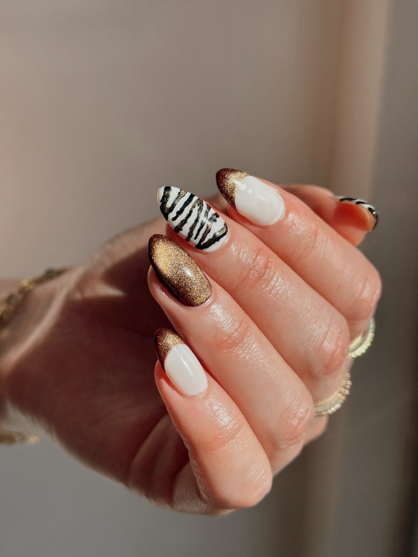 A metallic zebra print nail design