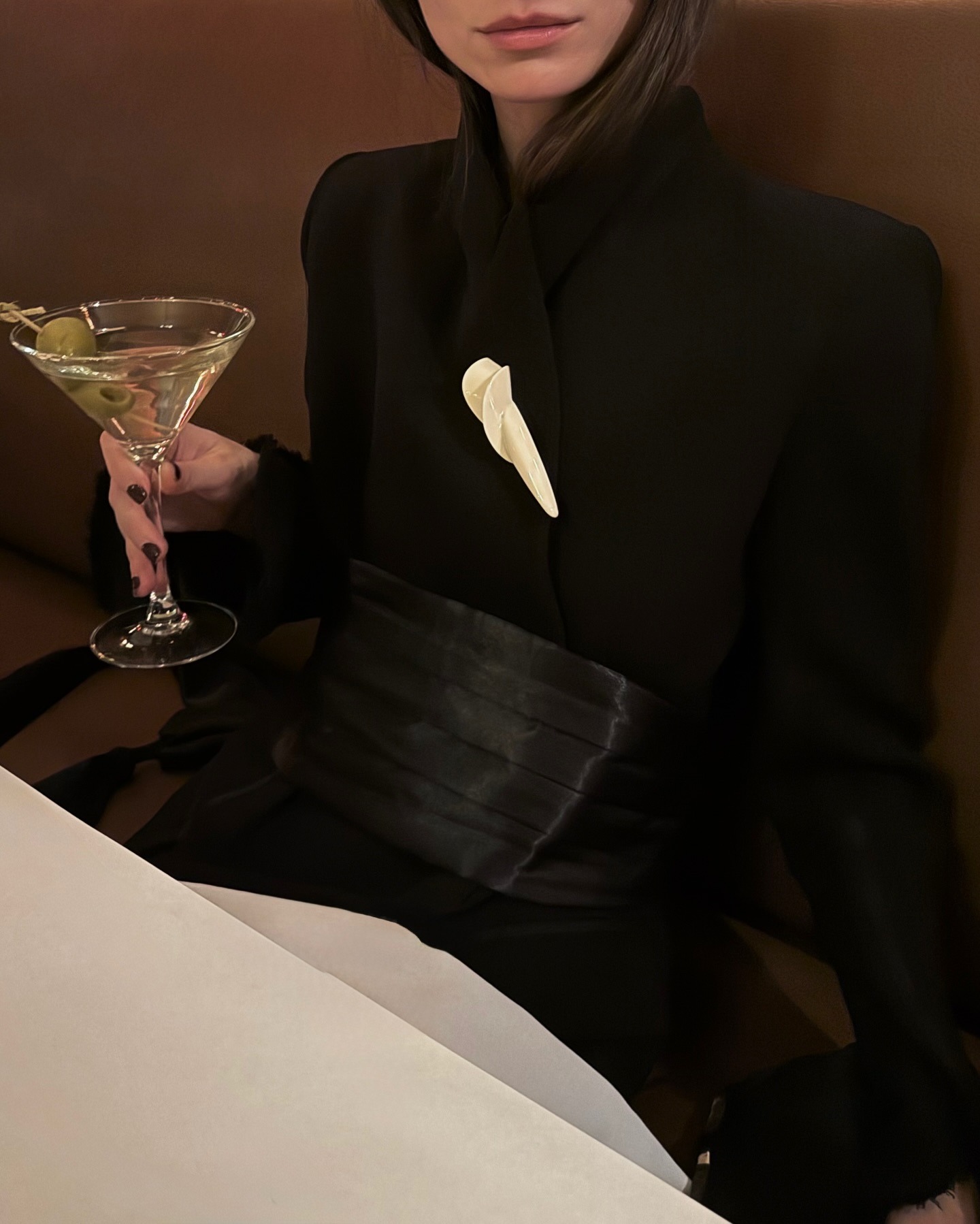 Woman wearing black satin cummerbund belt.