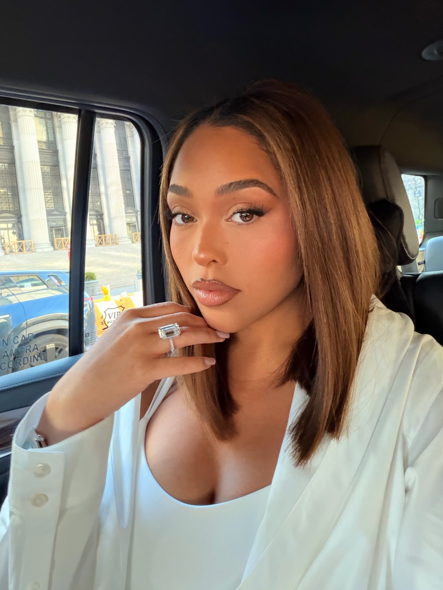 Jordyn Woods with caramel highlighted brown hair.
