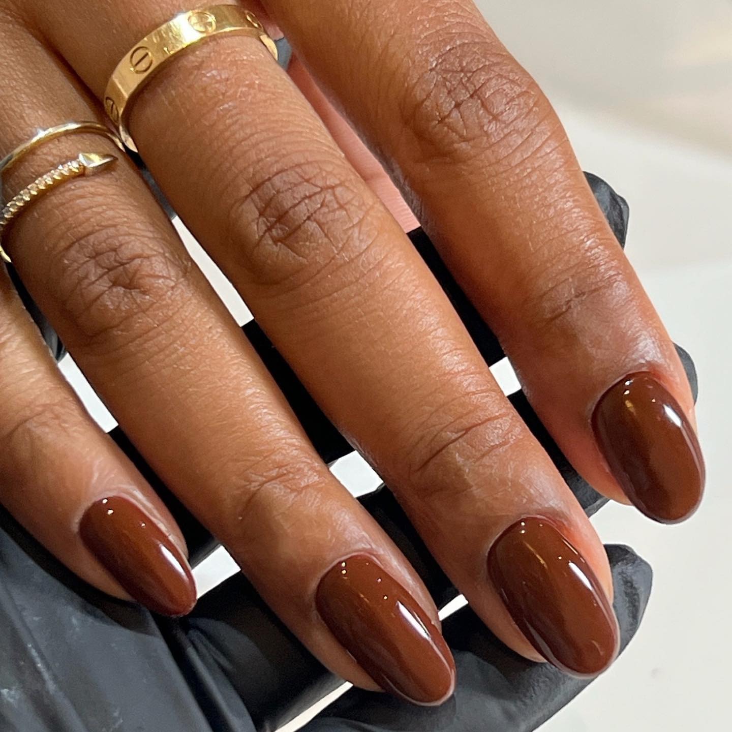A close-up of a chestnut brown manicure