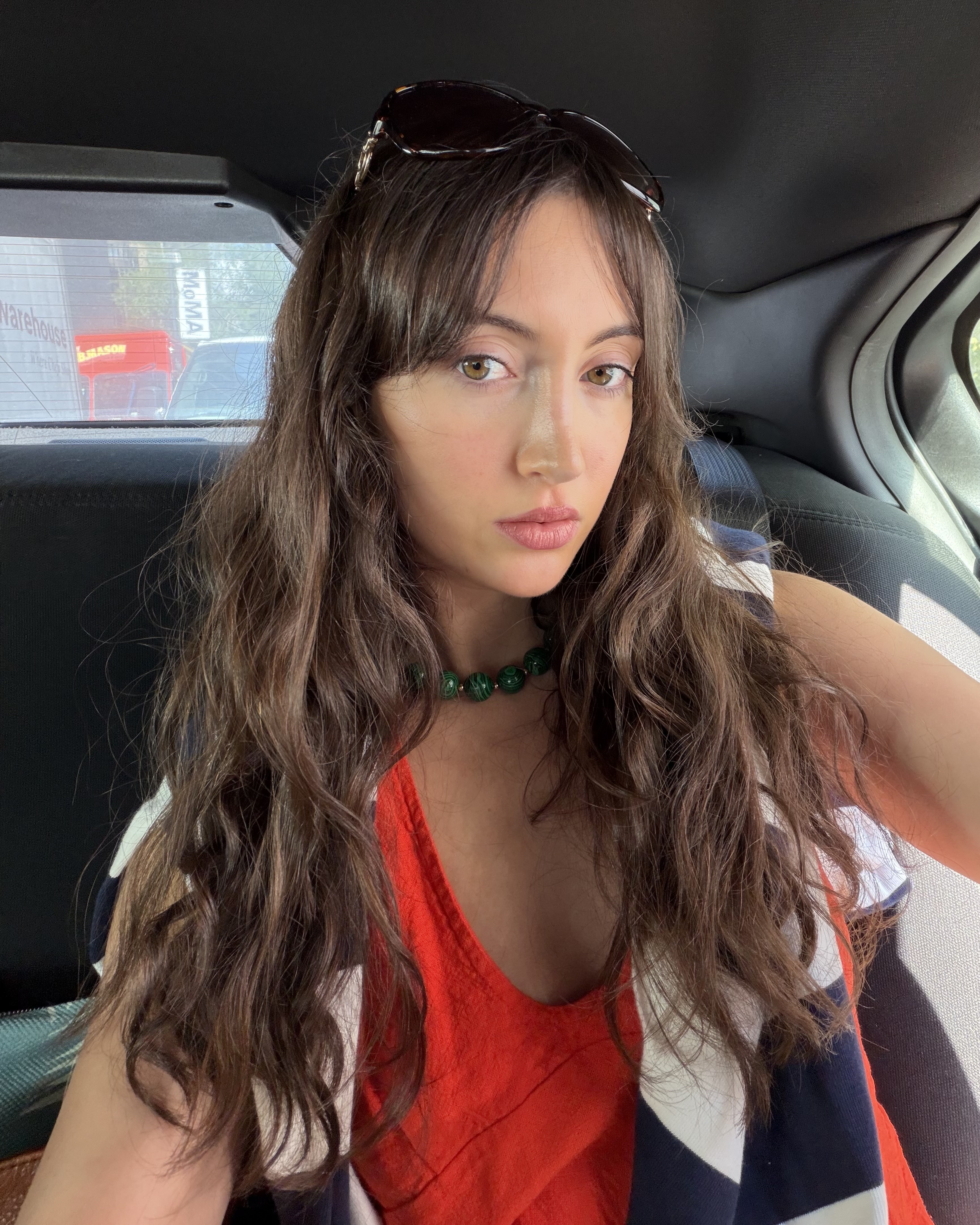 An image of Who What Wear associate beauty editor Alyssa Brascia with long, wavy brown hair.