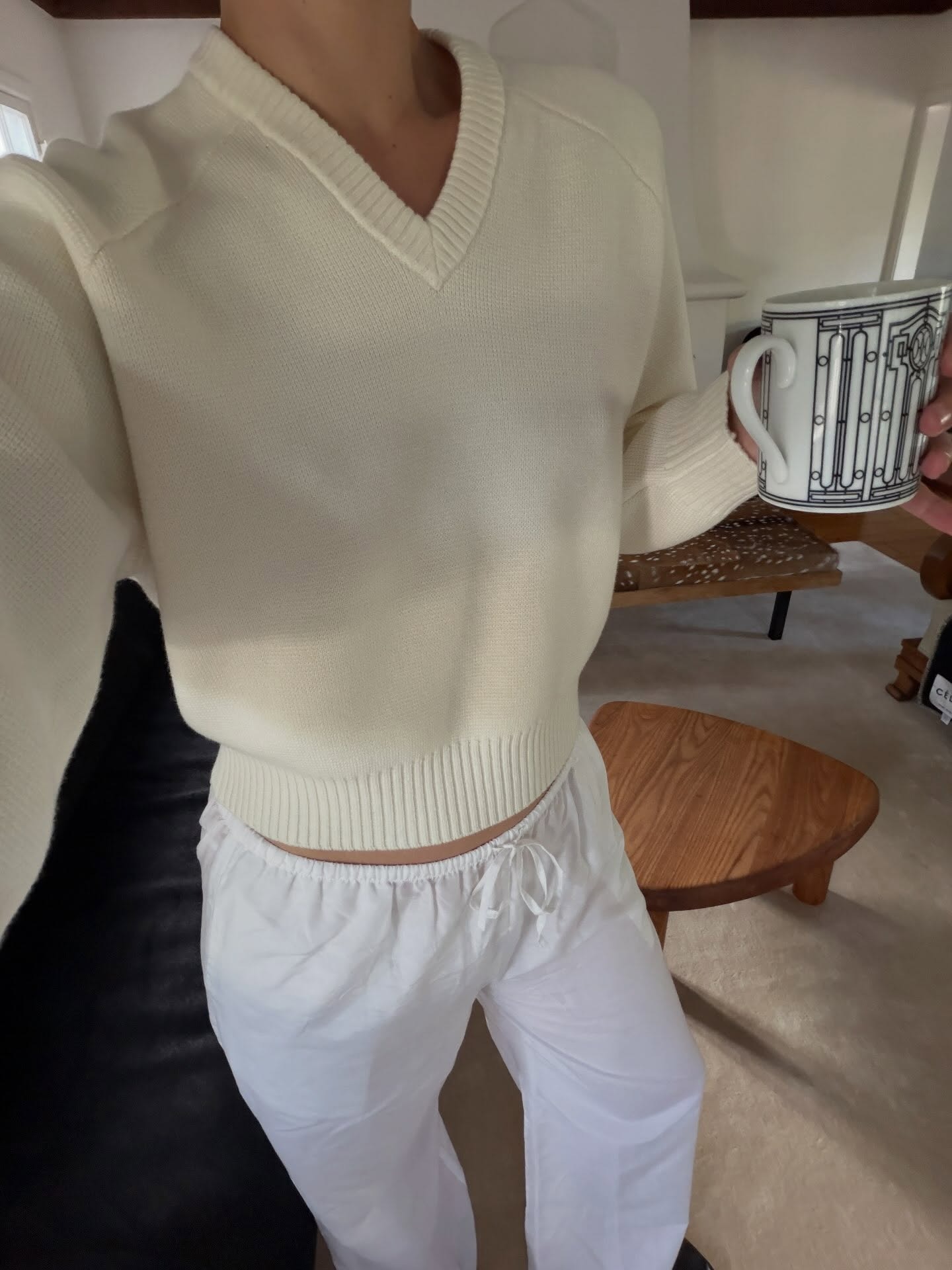 Christie Tyler wearing a sweater and poplin pants.
