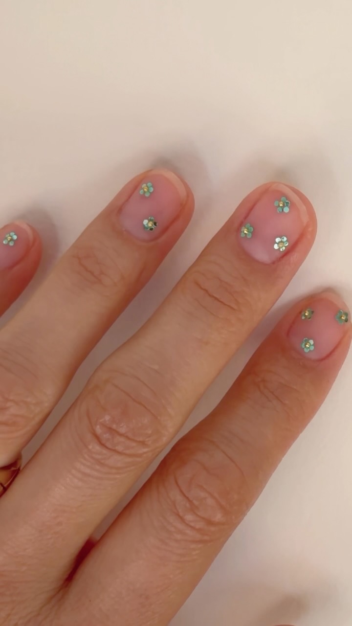 Short nails with tiny flower gem bedazzled nail art