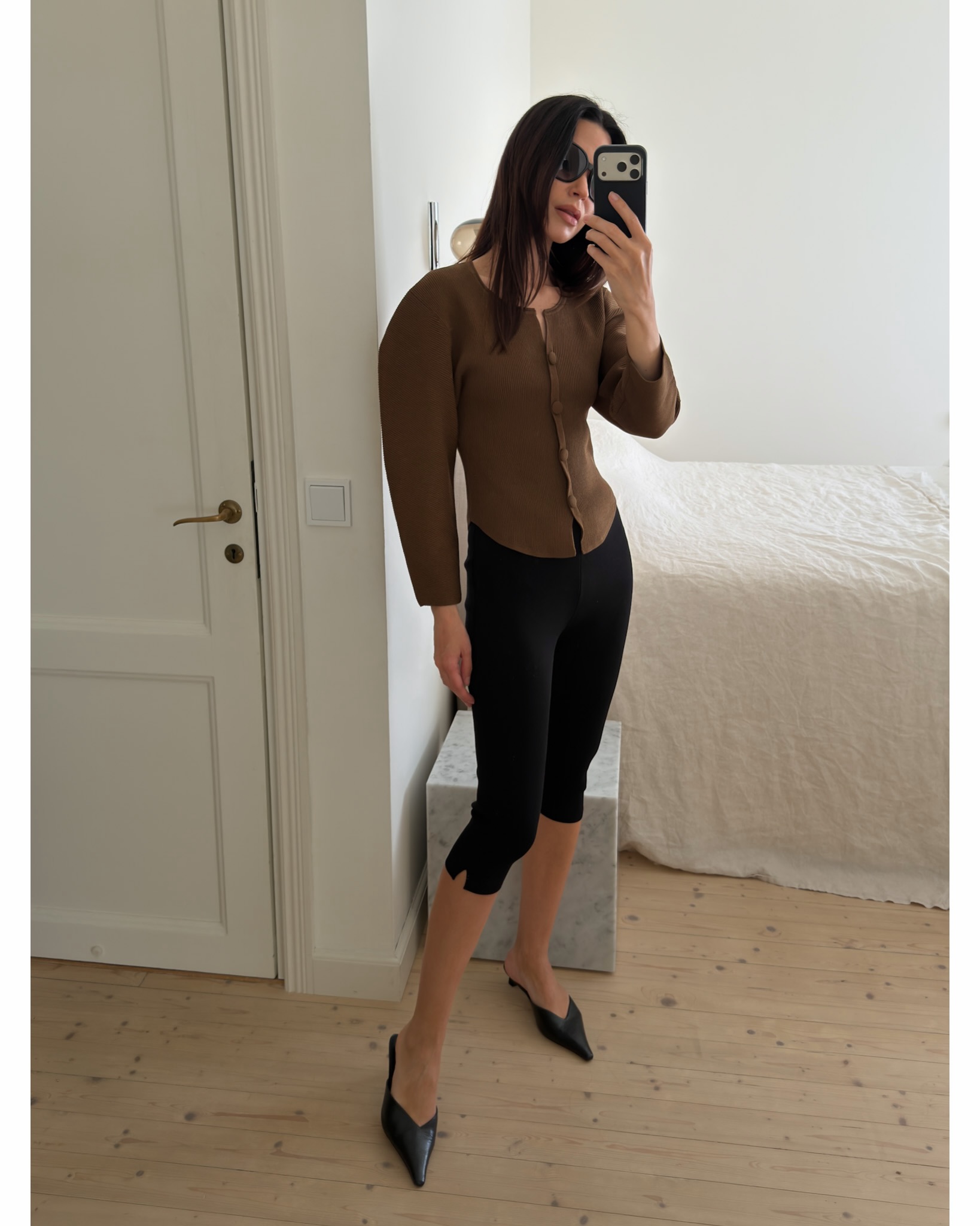 A woman wearing fall shoes with capri pants in 2026.