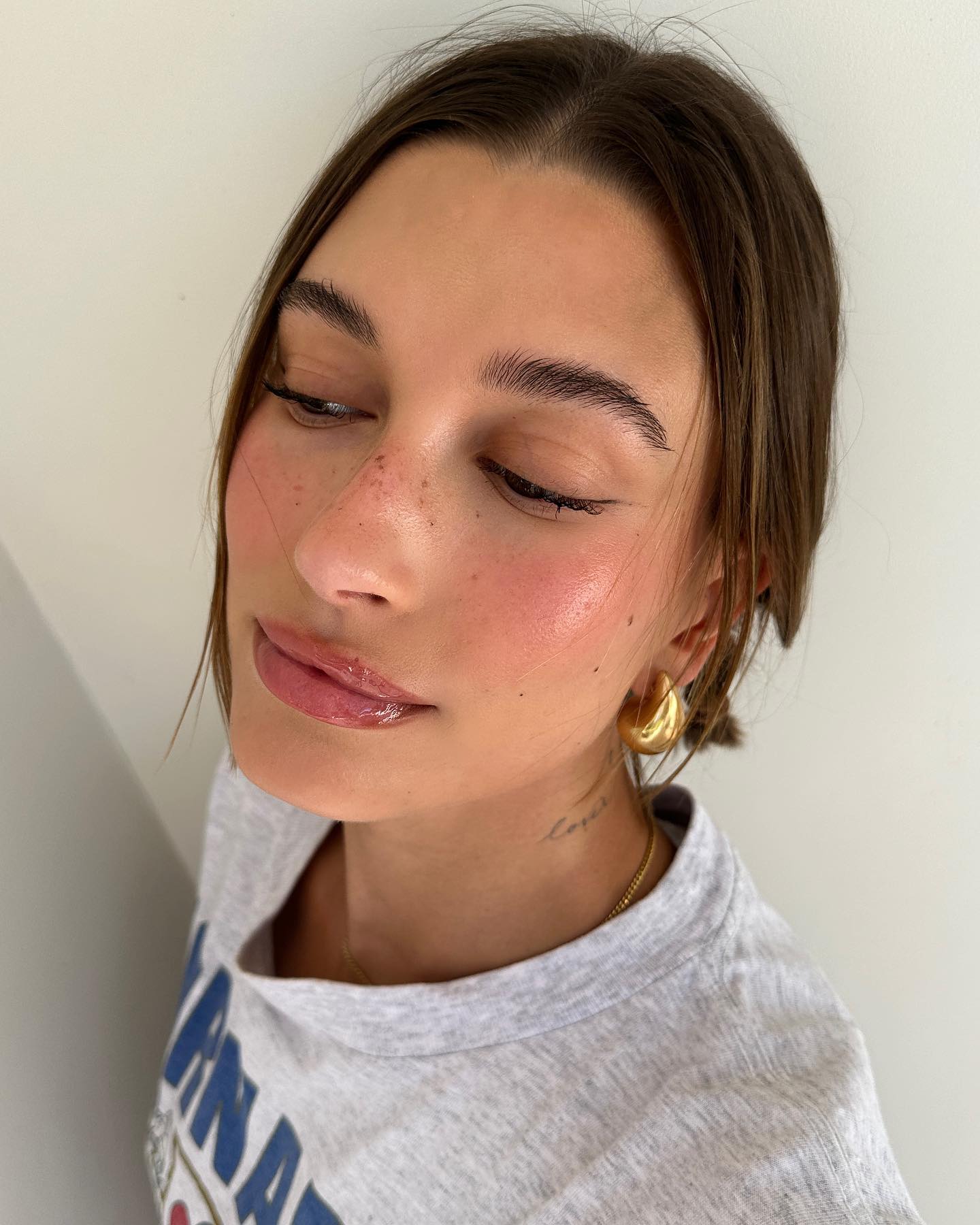 Hailey Bieber with freckly skin and blush - best products for hyperpigmentation