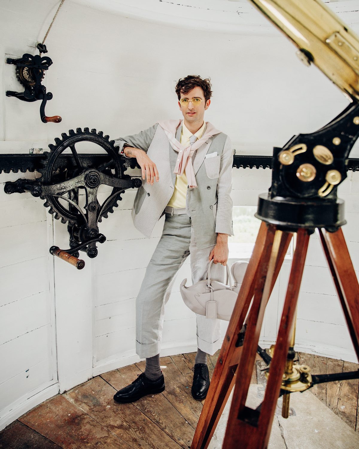 An image of @maximilianhurd wearing a designer bag.