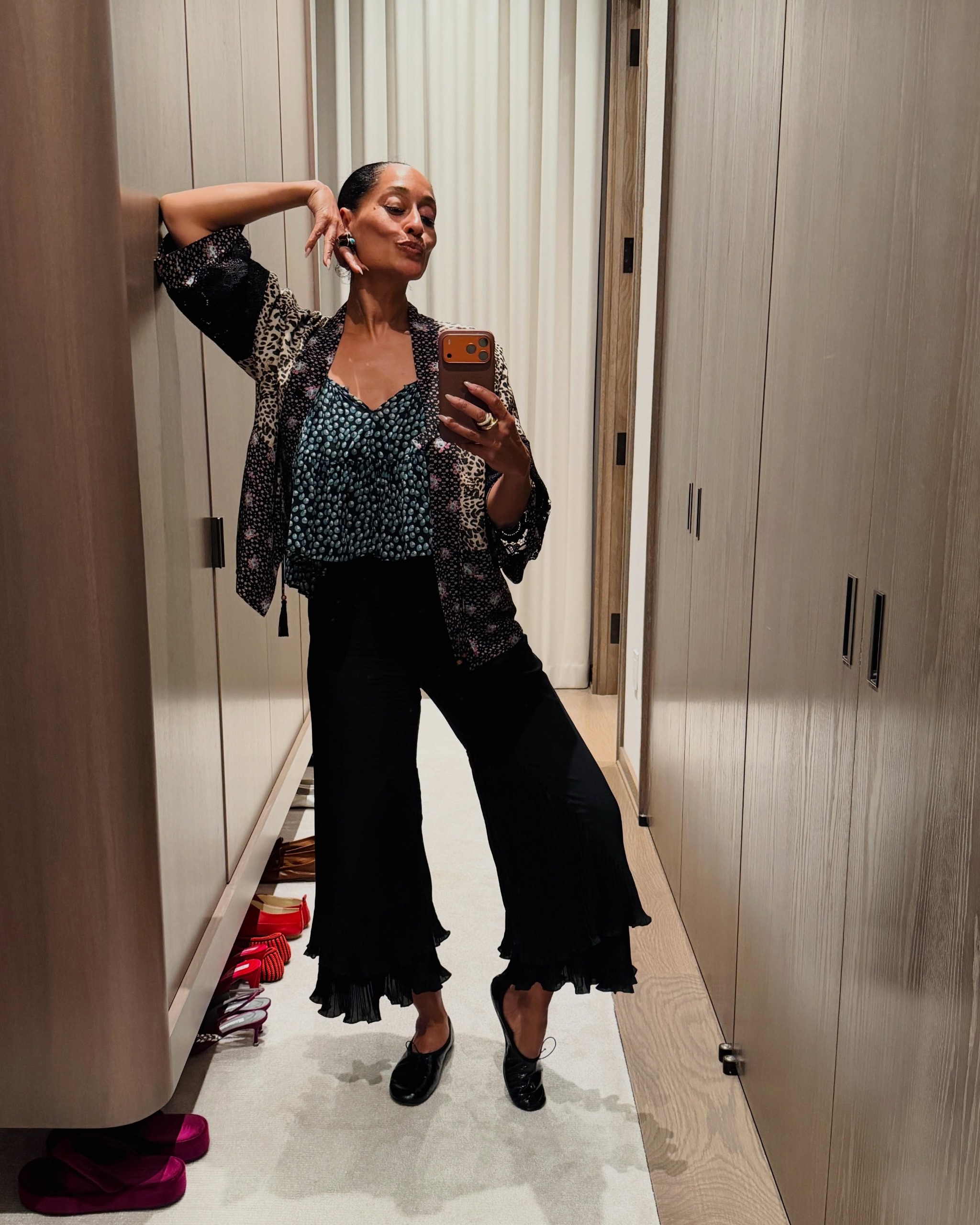Tracee Ellis Ross wears high-vamp flat shoes with jeans and cropped trousers.