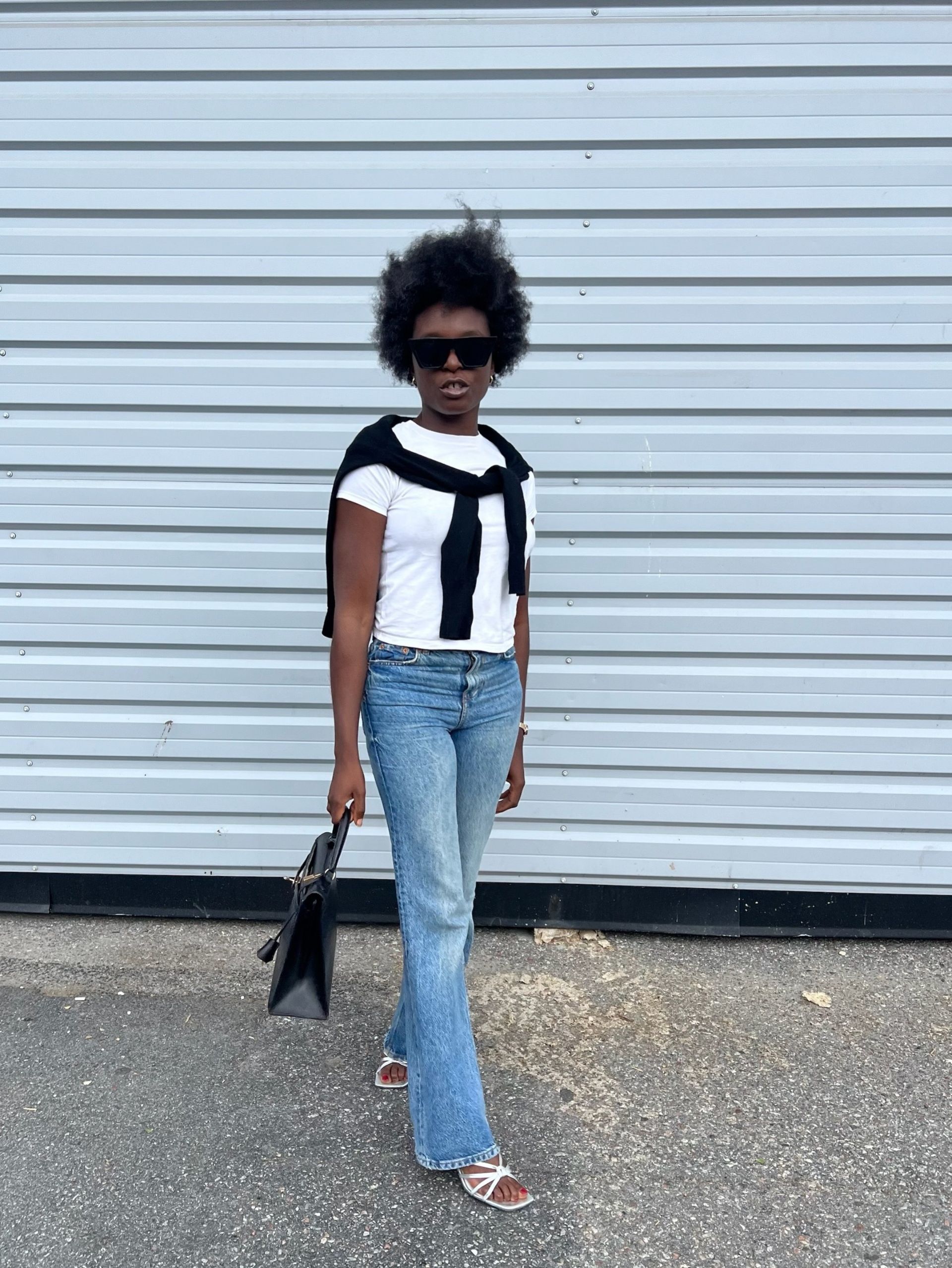 A woman wearing low rise bootcut jeans in 2026.