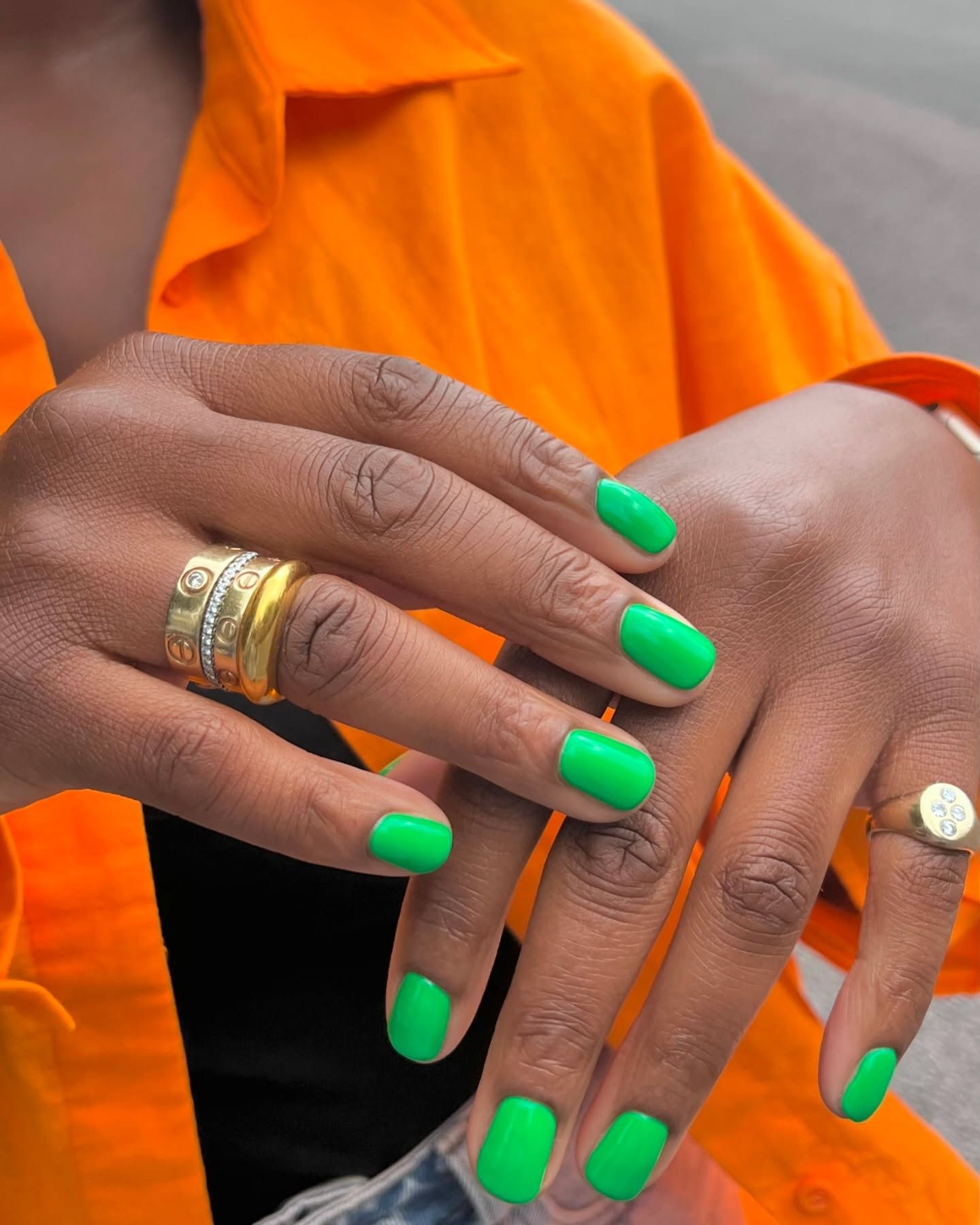 Bright green nail polish on short nails