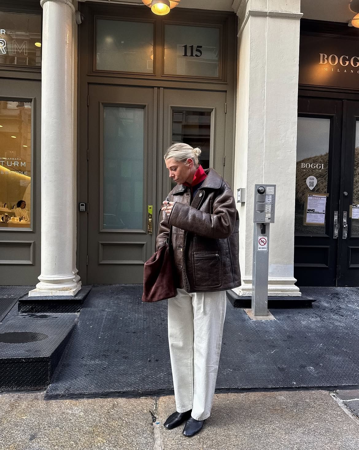 Brown leather jacket and white jeans.