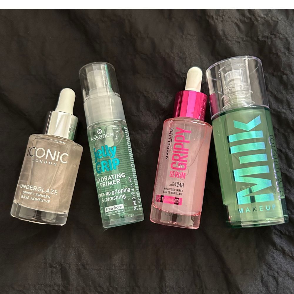 a close up shot of Iconic London's Underglaze Grippy Primer, essence's Jelly Grip Hydrating Primer, Maybelline's the Grippy Serum Primer, and Milk Makeup's Hydro Grip Primer
