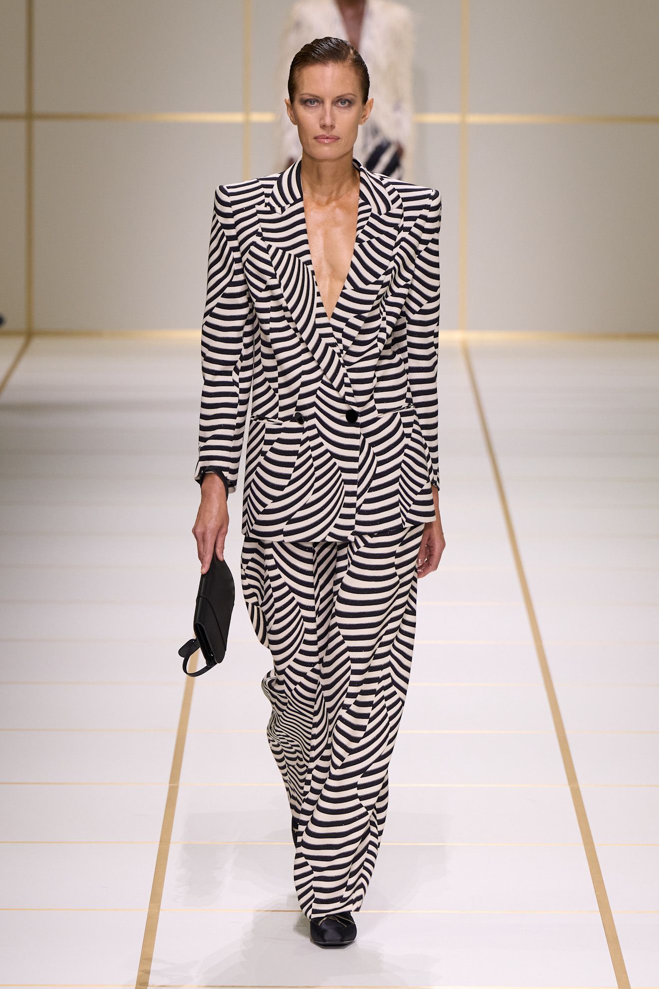A model walks the giorgio armani s/s 27 runway.