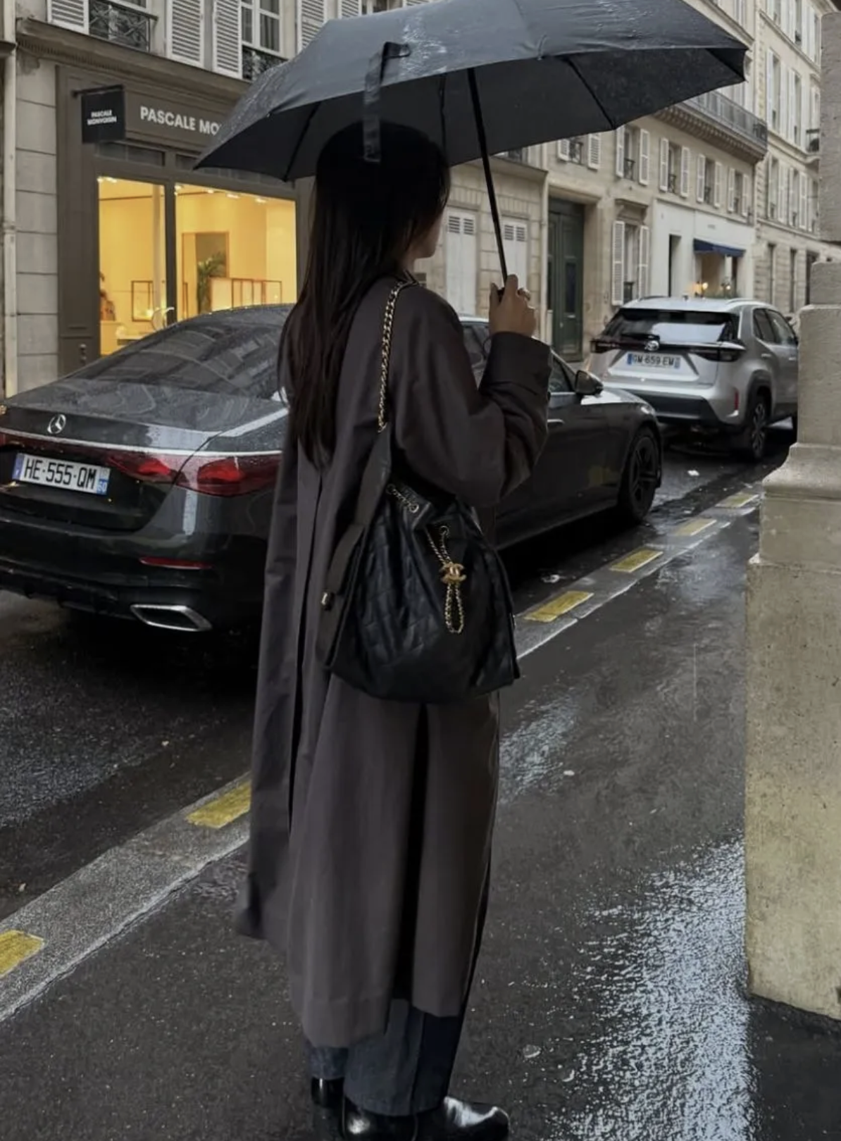 A photo of @michellelin.lin holding an umbrella in the rain
