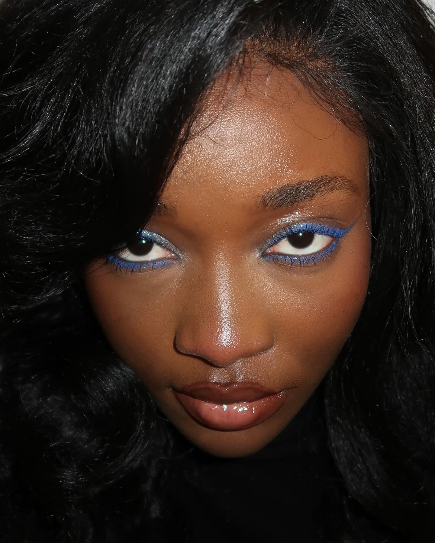 Photo of a woman wearing blue eyeliner