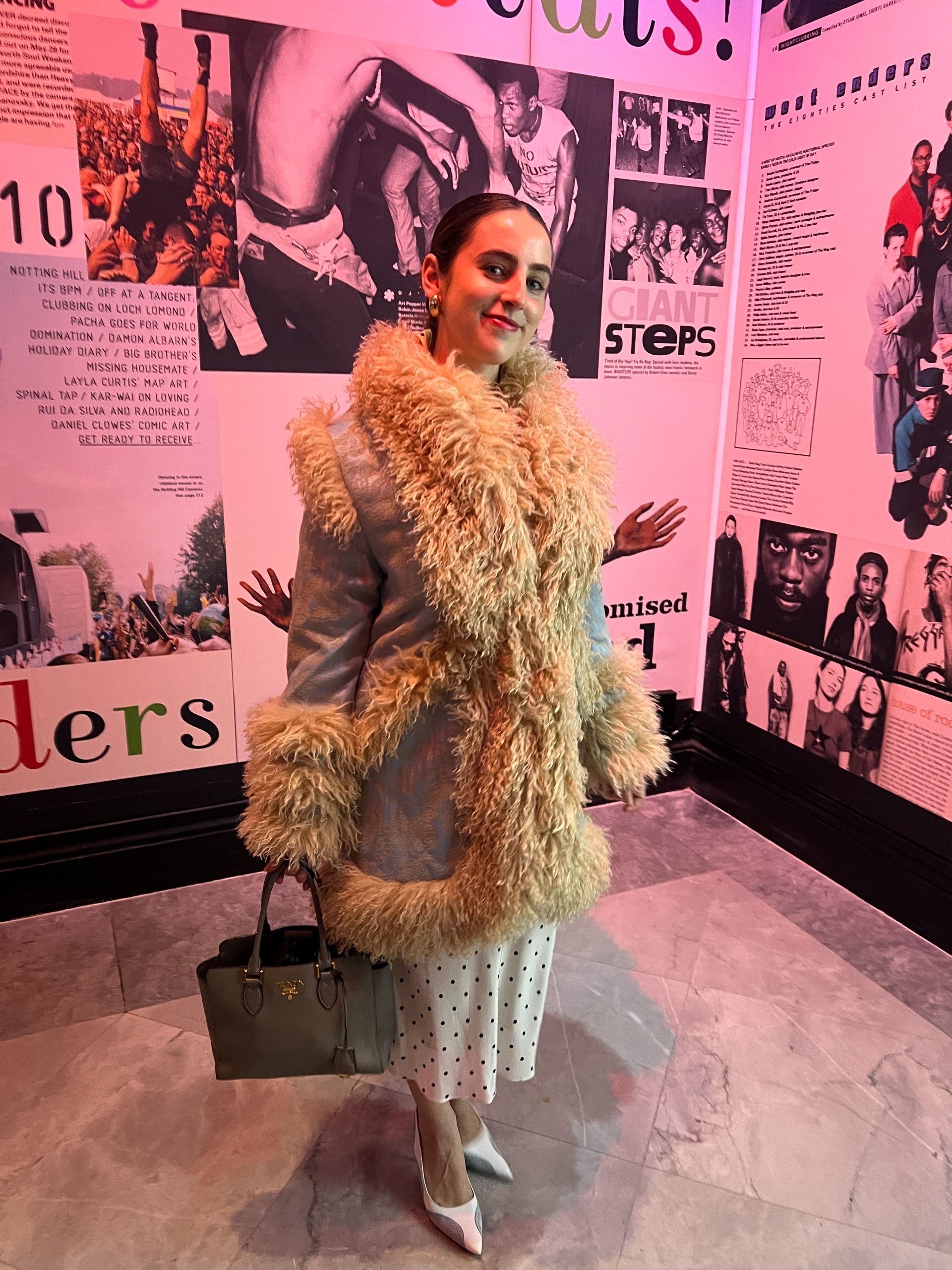 An image of Who What Wear writer Ava Gilchrist wearing a Penny Lane coat with a polka-dot dress.