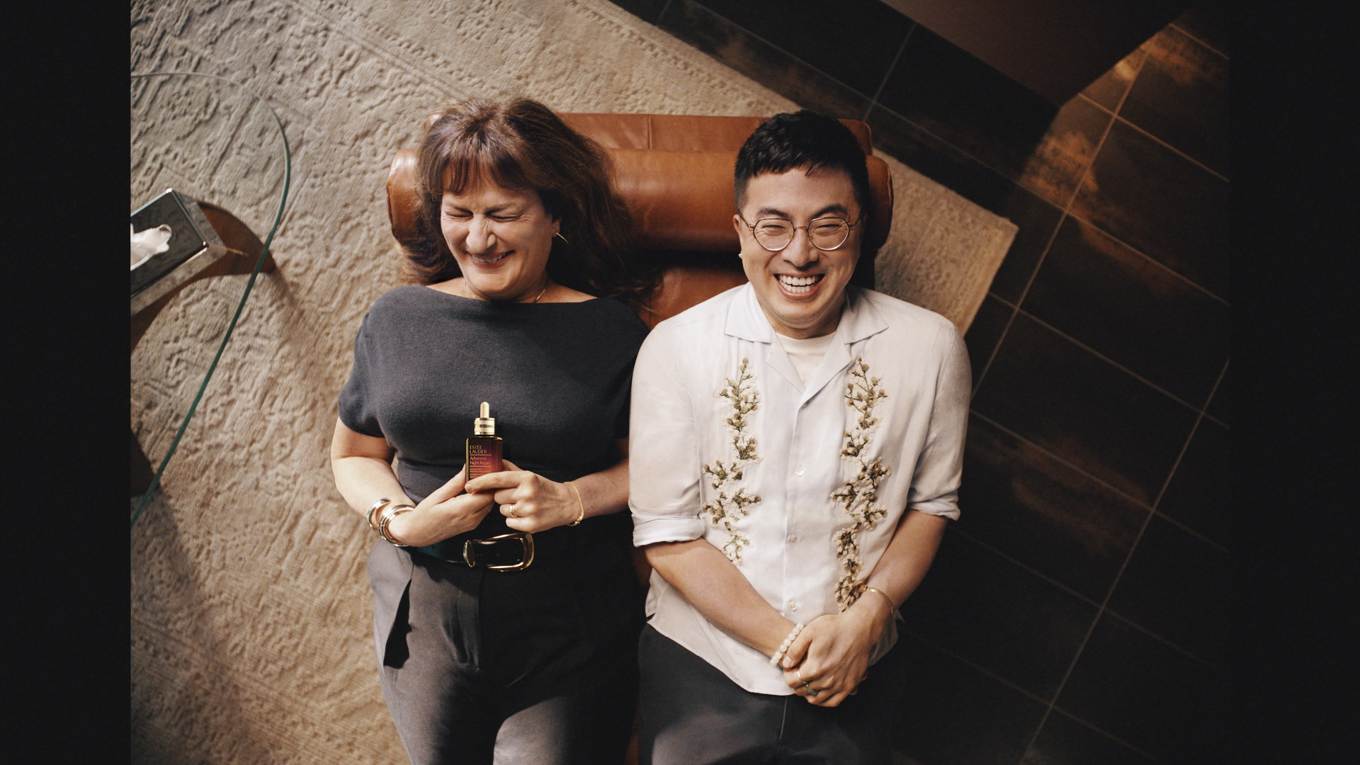 Est&eacute;e Lauder Guilty as Skin campaign image of Bowen Yang and Ana Gasteyer.
