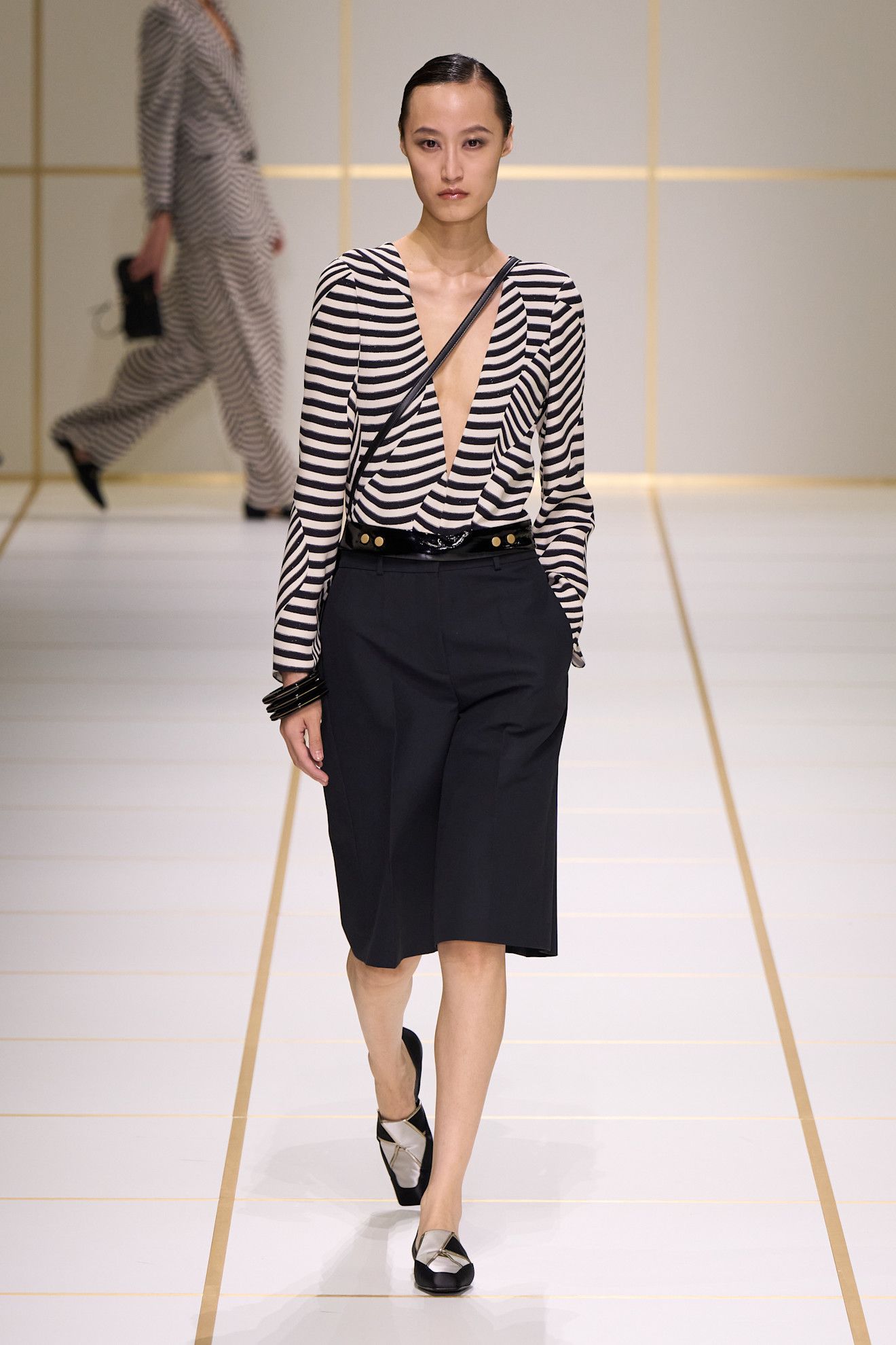 a model walks the giorgio armani s/s 27 runway.