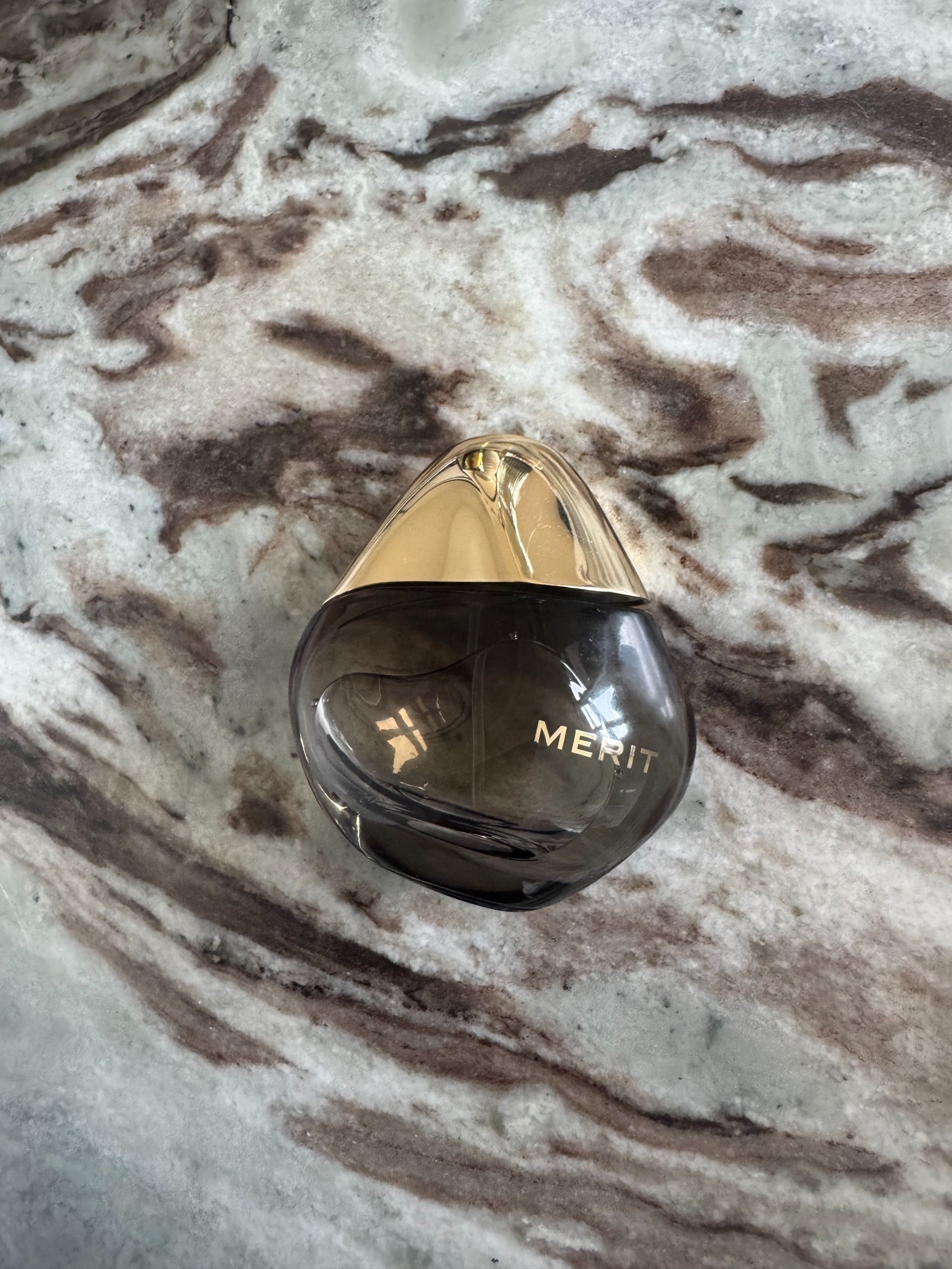 A bottle of Merit Retrospect perfume