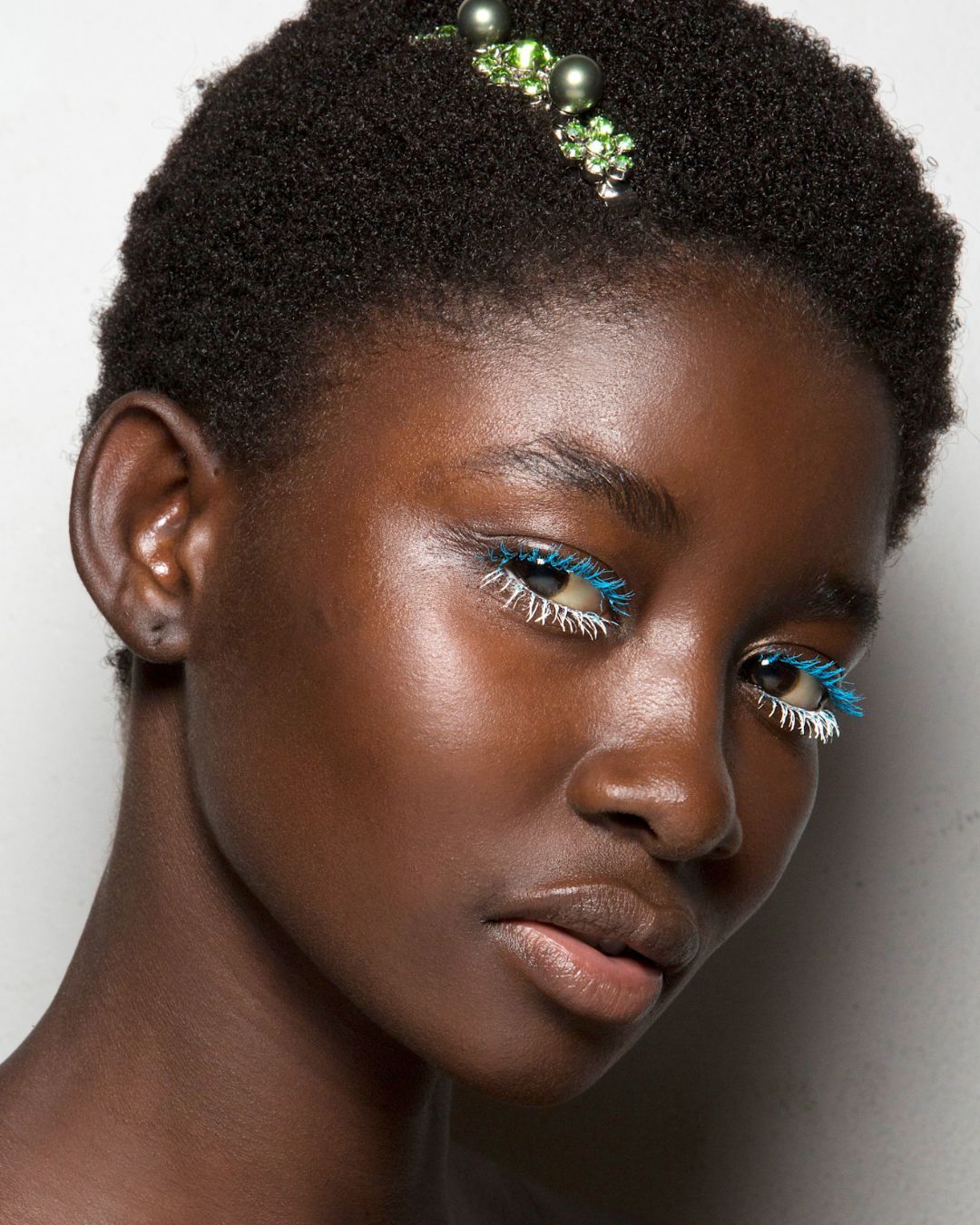 A woman with blue and white eyeshadow