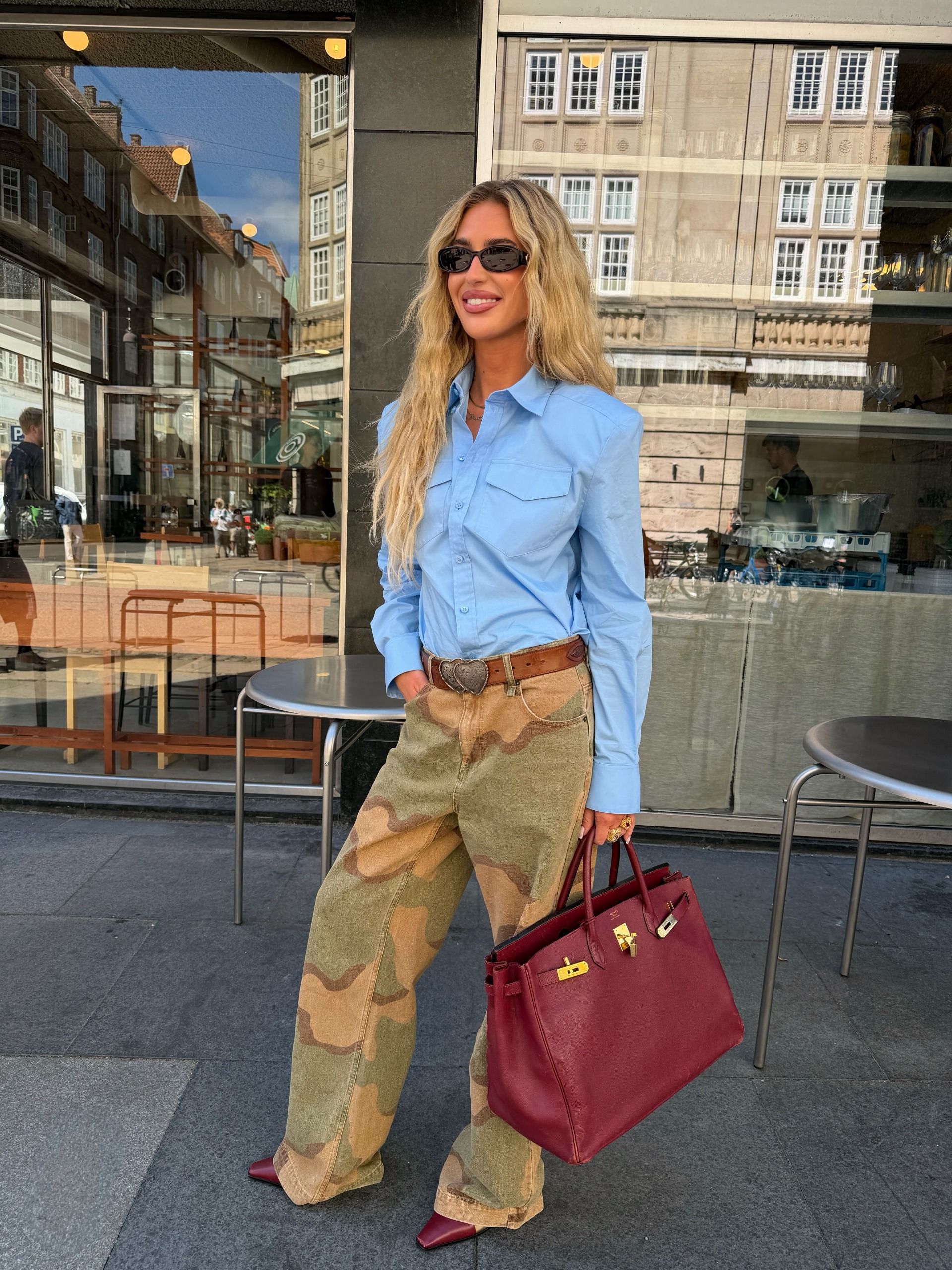 An image of a woman wearing best shoes to wear with camo pants fall 2026