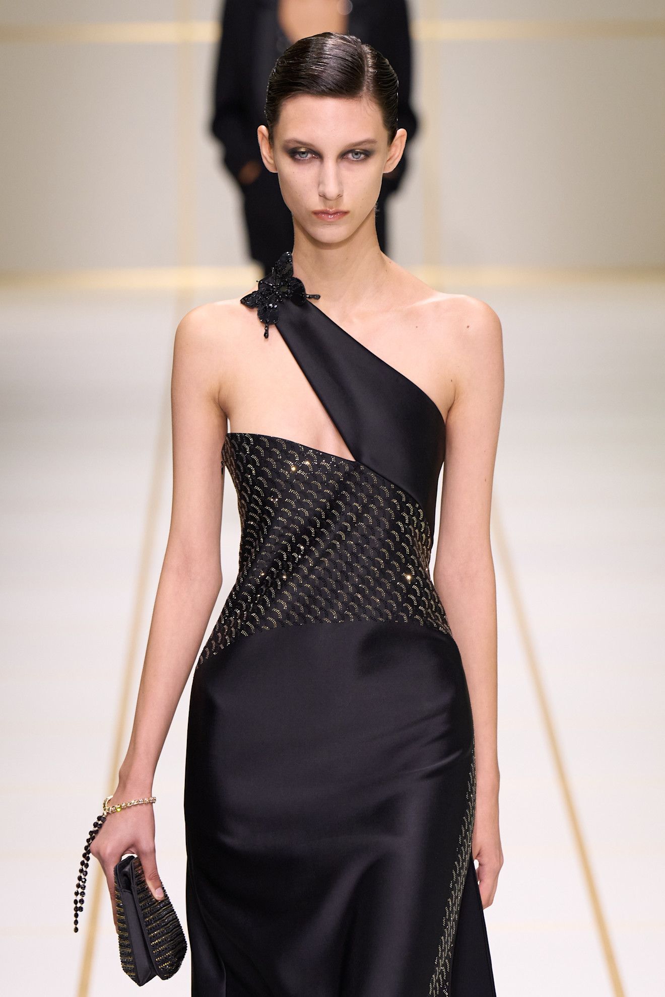 a model walks the giorgio armani s/s 27 runway.