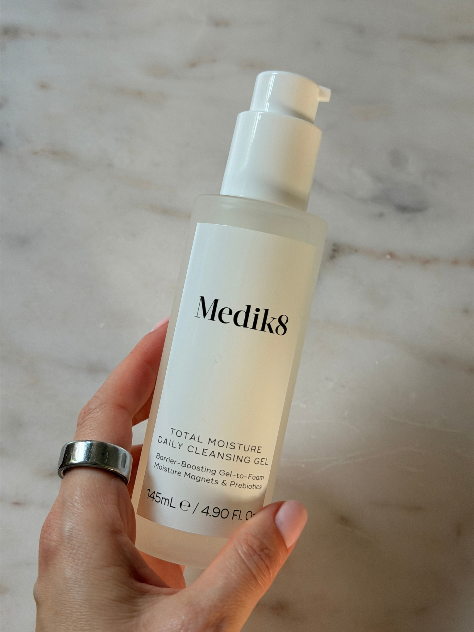 Freelance beauty editor Grace Day holding the Medik8 cleanser