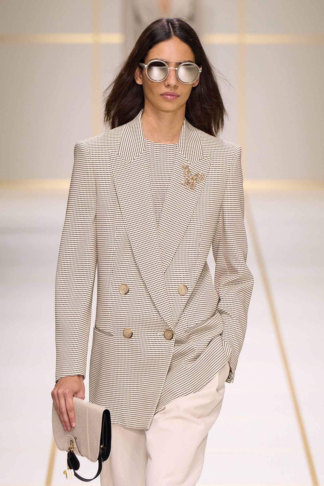 a model walks the giorgio armani s/s 27 runway.