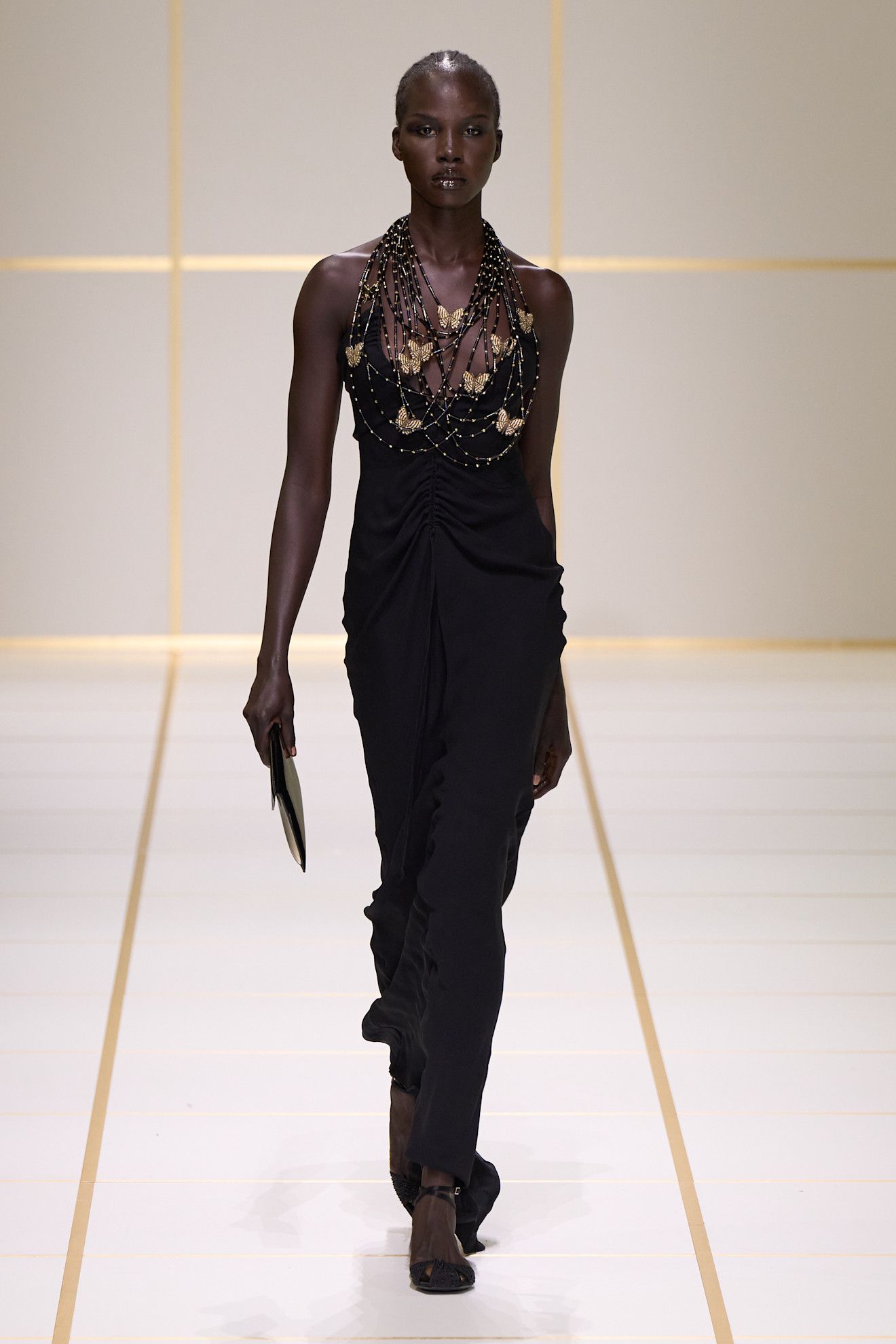 a model walks the giorgio armani s/s 27 runway.