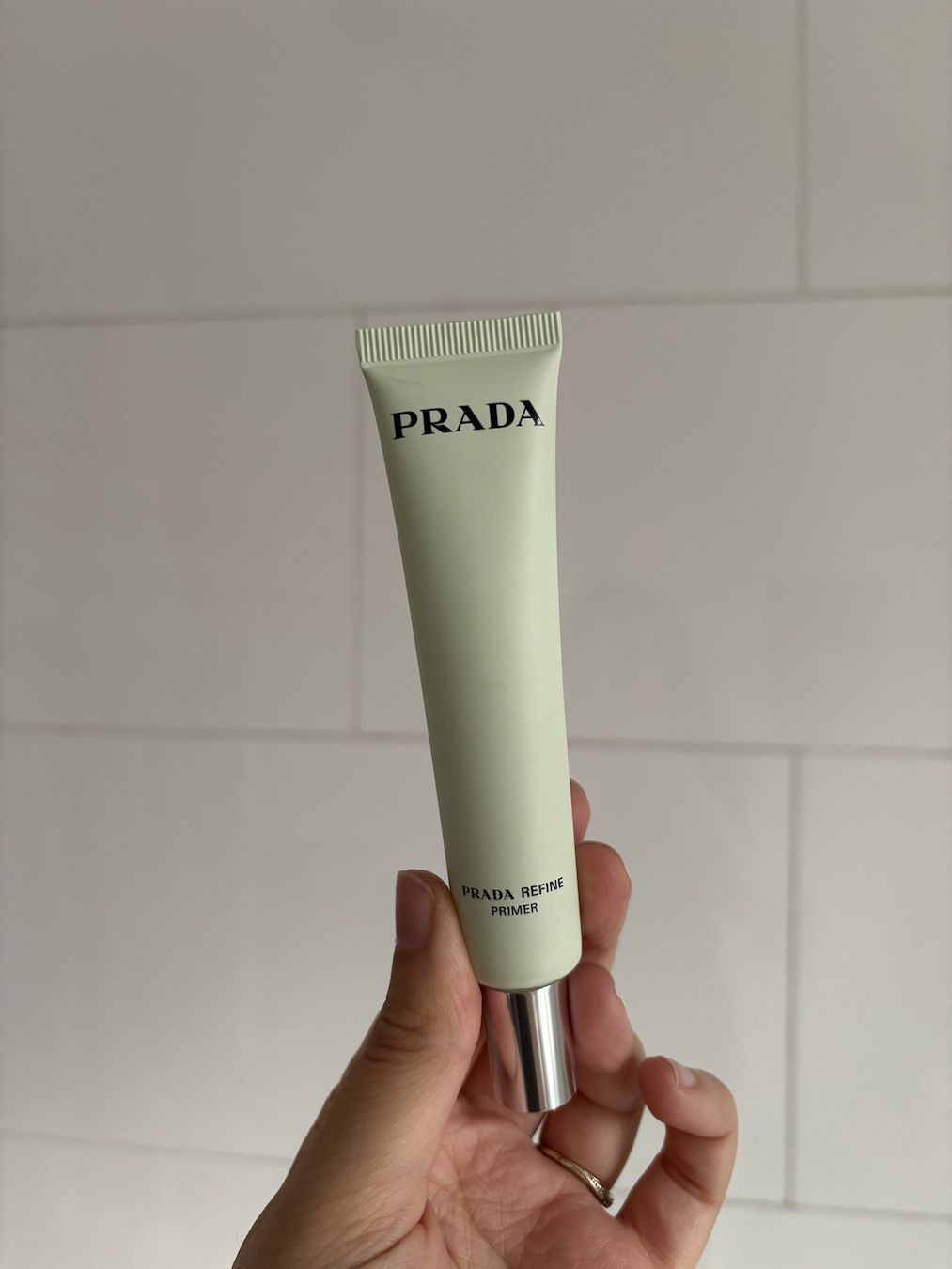 Mica Ricketts holding Prada Refine Blurring Extending Primer