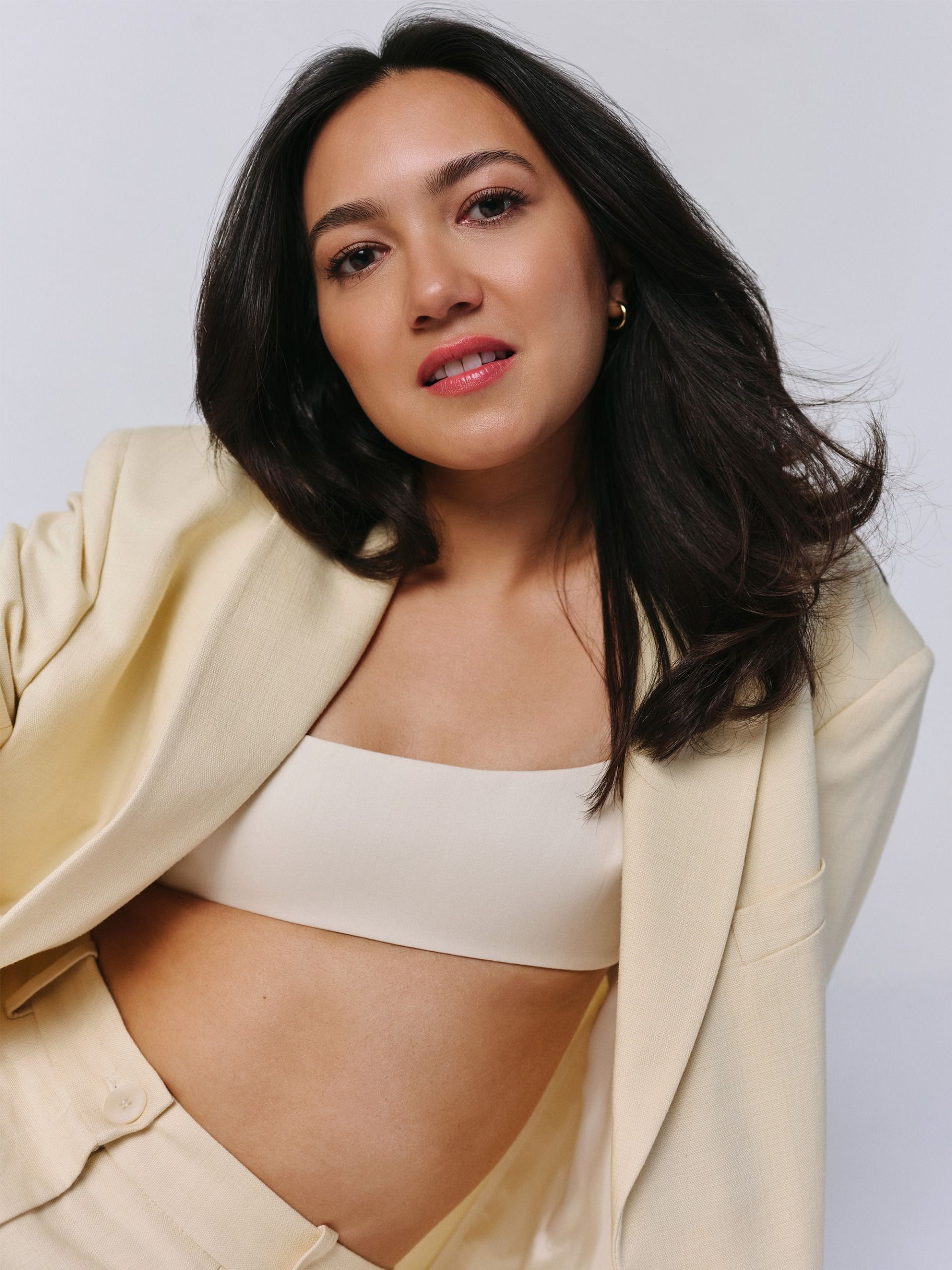 Rachel Marsh wearing a butter yellow suit with a white bralette.