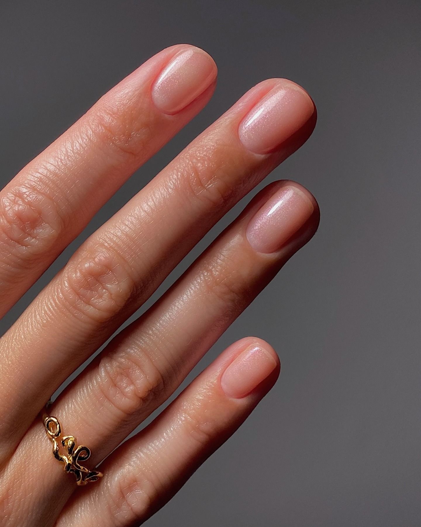A clear, slightly shimmery manicure