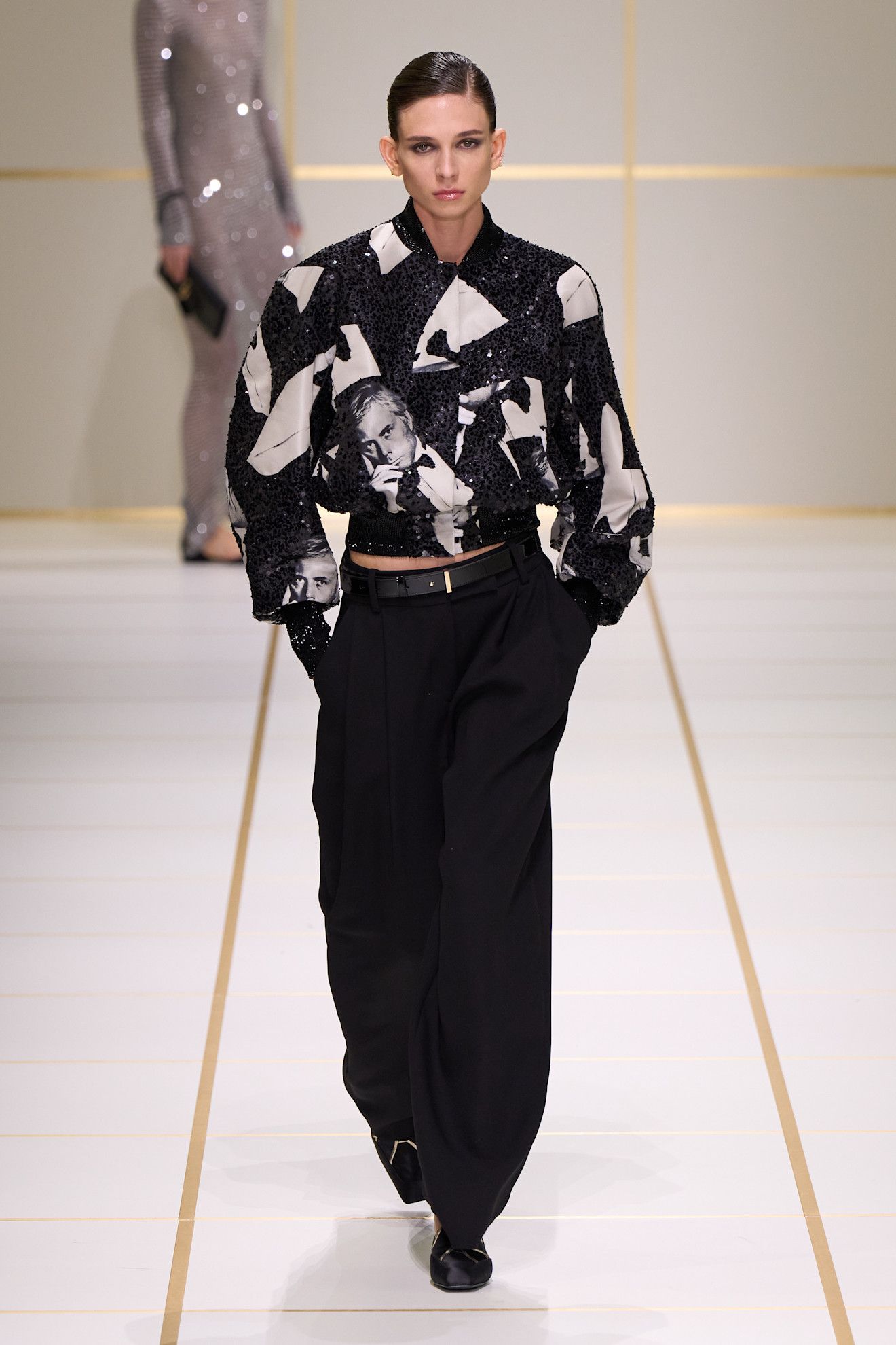 a model walks the giorgio armani s/s 27 runway.