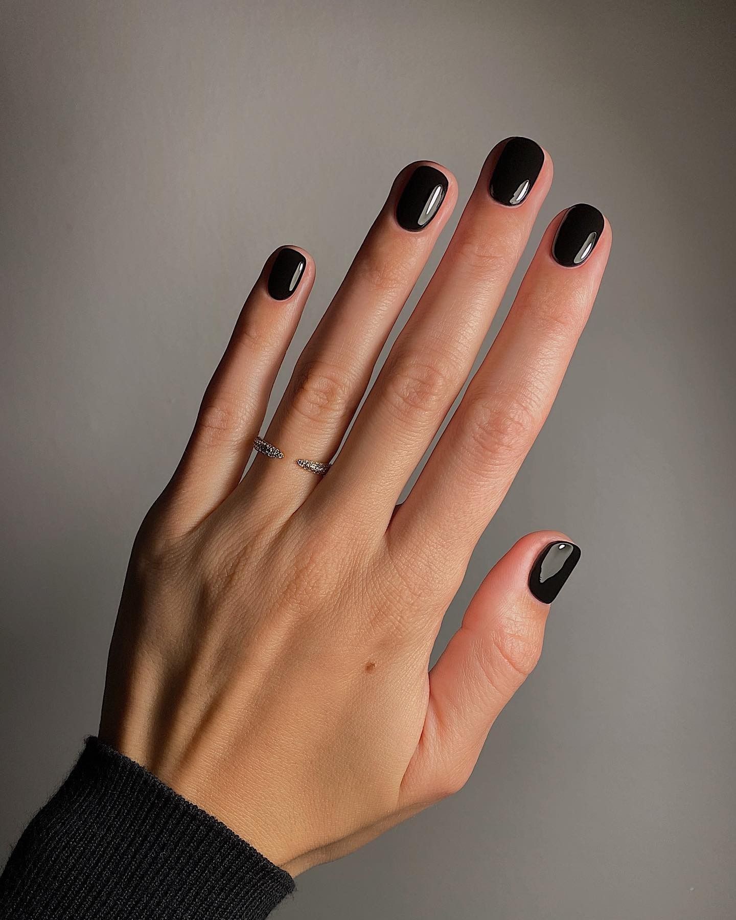 A black manicure on short nails